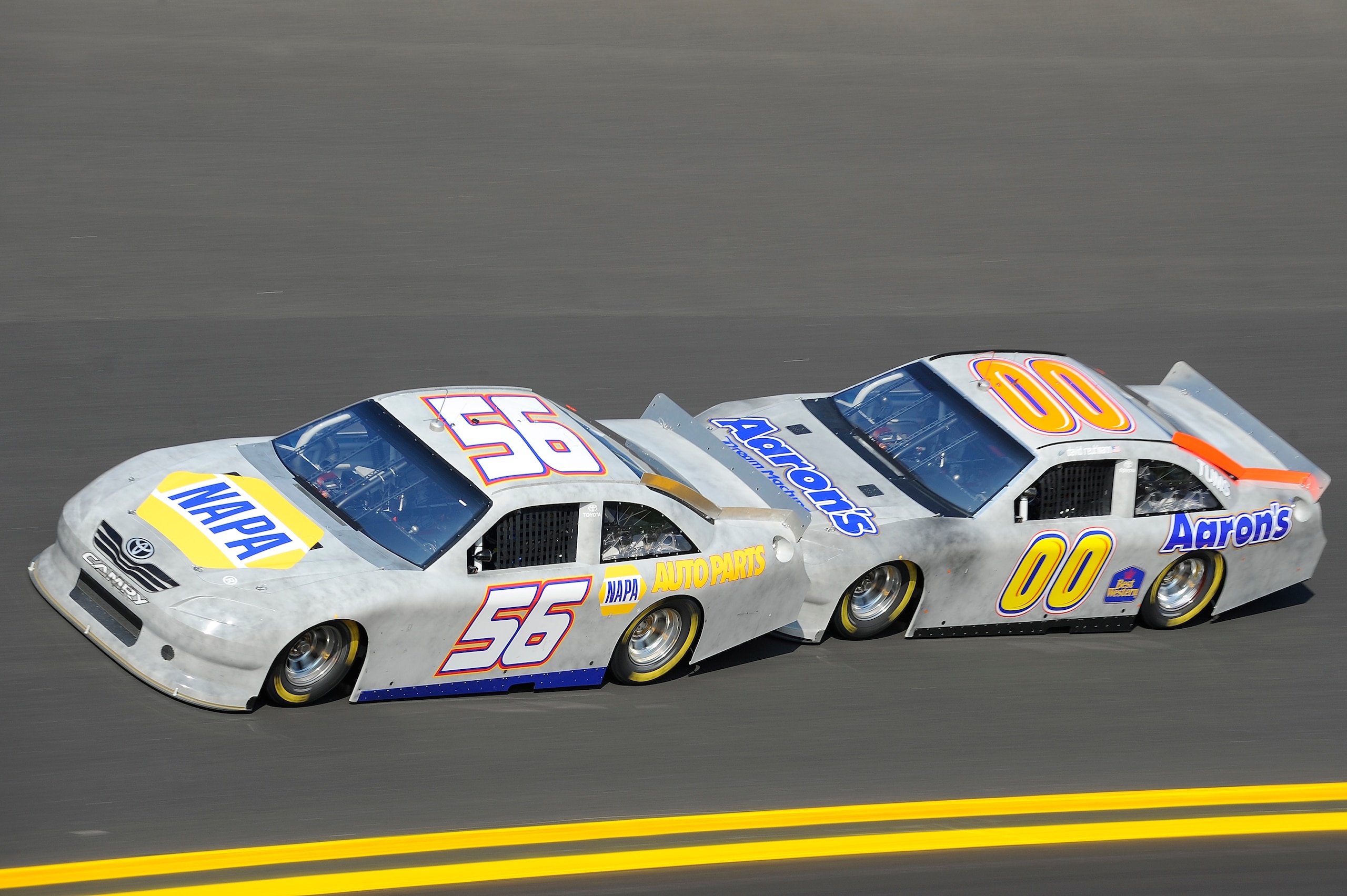 DAYTONA BEACH, FL - JANUARY 20:  Martin Truex Jr., driver of the #56 NAPA Auto Parts Toyota, leads the way for teammate David Reutimann, driver of the #00 Aaron's Toyota, during testing at Daytona International Speedway on January 20, 2011 in Daytona Beac