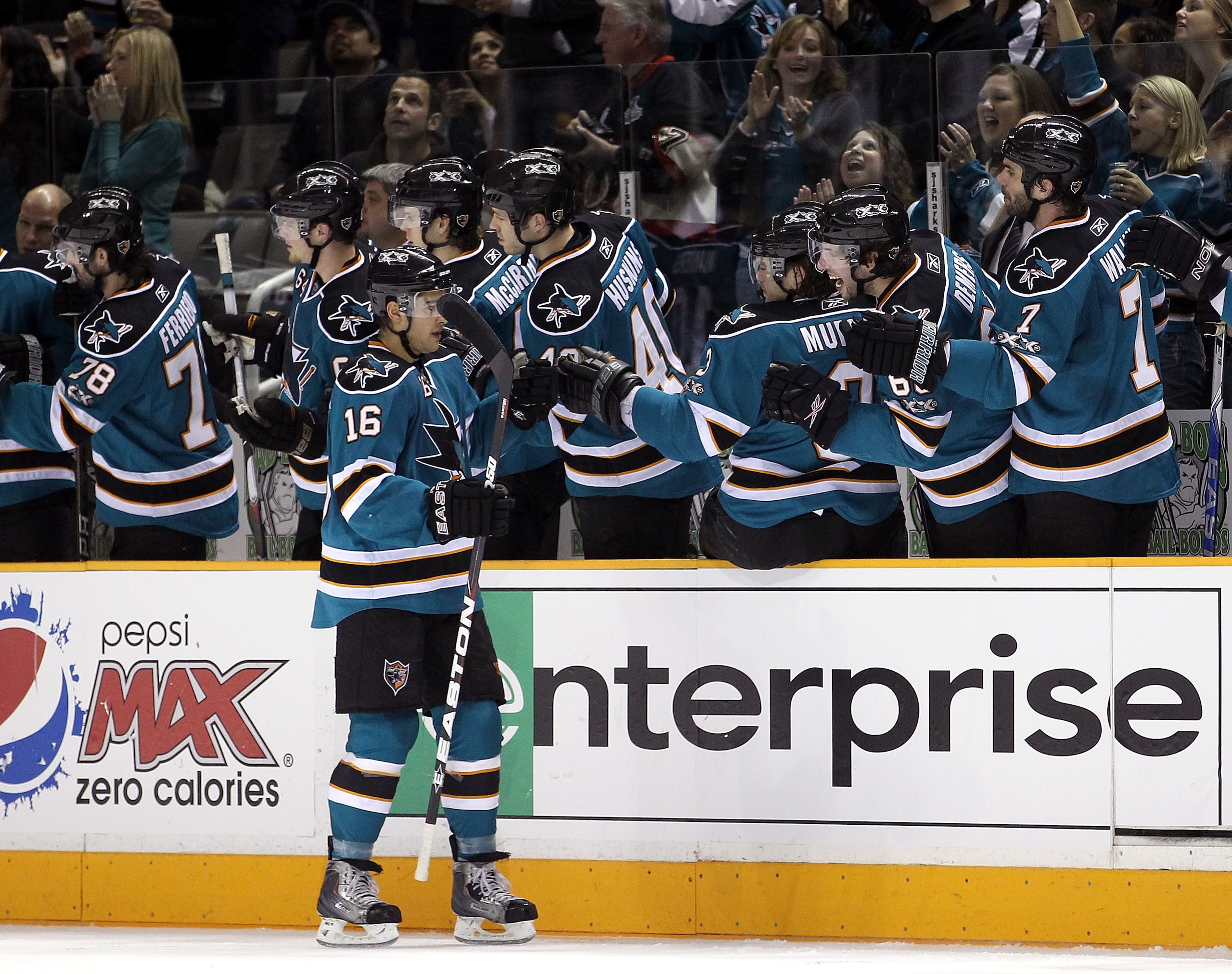 SAN JOSE, CA - JANUARY 22:  Devin Setoguchi #16 of the San Jose Sharks is congratulated by teammates after he scored a goal against the Minnesota Wild at HP Pavilion on January 22, 2011 in San Jose, California.  (Photo by Ezra Shaw/Getty Images)