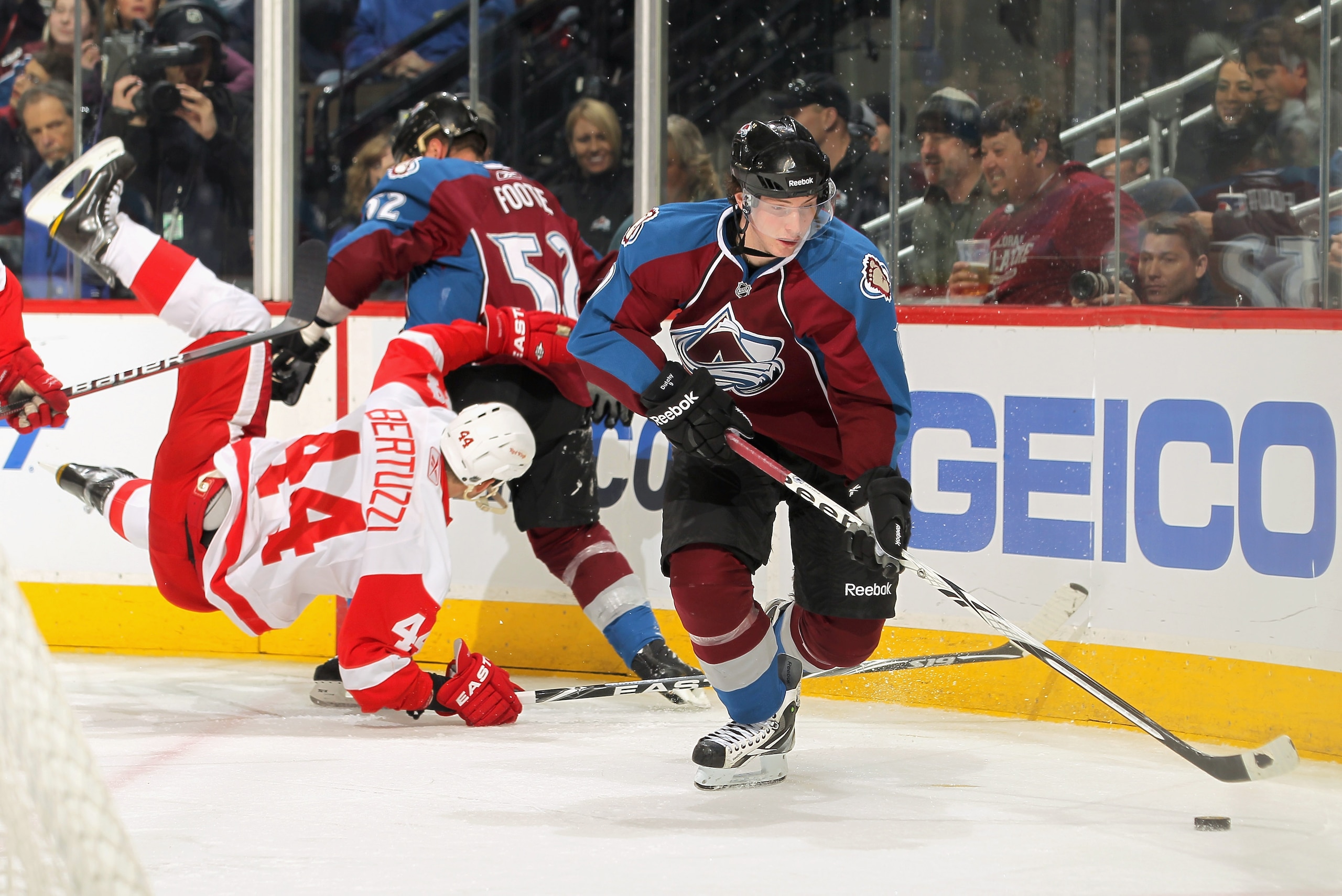 DENVER, CO - JANUARY 10:  Matt Duchene #9 of the Colorado Avalanche controls the puck as teammate Adam Foote #52 puts a hit on Todd Bertuzzi #44 of the Detroit Red Wings at the Pepsi Center on January 10, 2011 in Denver, Colorado.  (Photo by Doug Pensinge