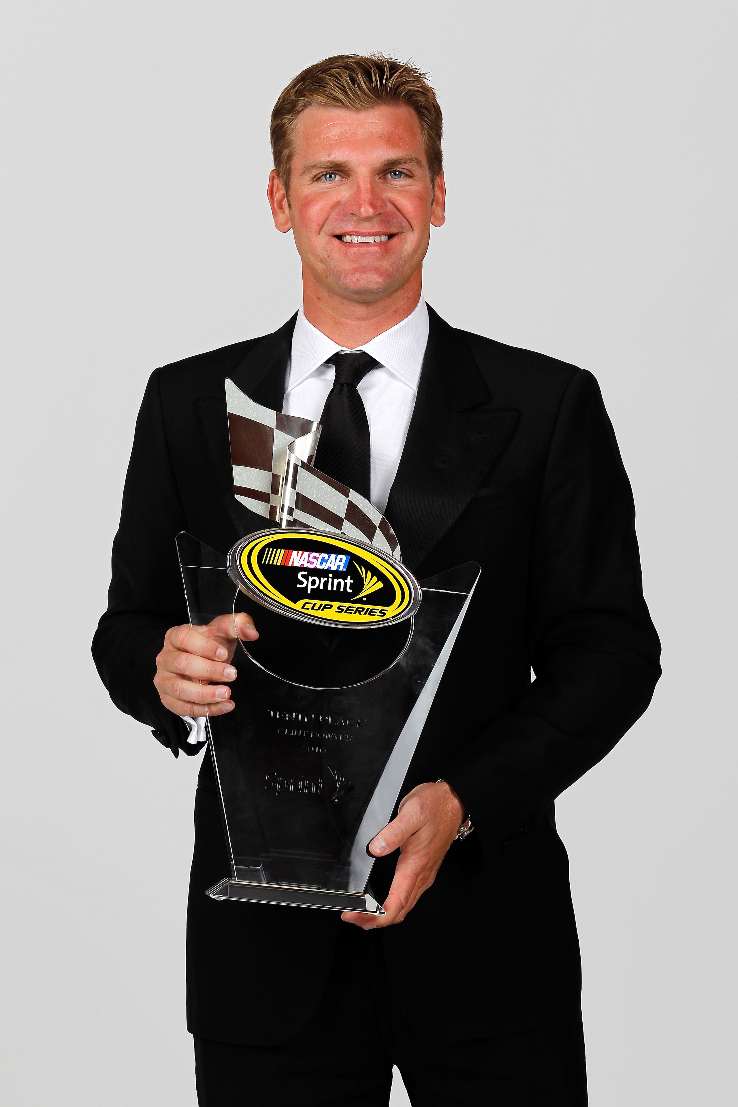 LAS VEGAS, NV - DECEMBER 03:  NASCAR driver Clint Bowyer poses with his 10th place trophy during the NASCAR Sprint Cup Series awards banquet at the Wynn Las Vegas Hotel on December 3, 2010 in Las Vegas, Nevada.  (Photo by Todd Warshaw/Getty Images for NAS