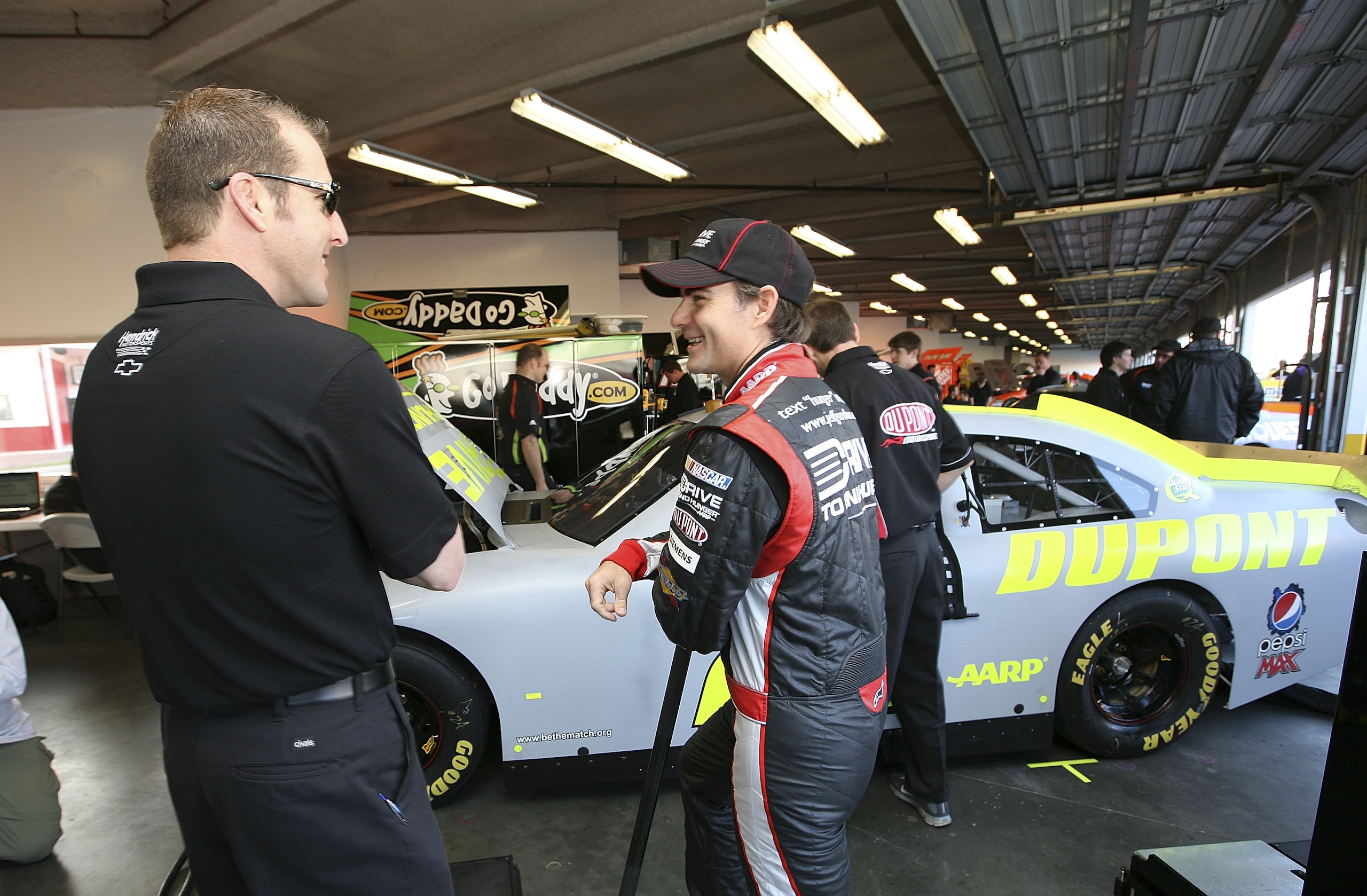 DAYTONA BEACH, FL - JANUARY 20:  Jeff Gordon, driver of the #24 Dupont Chevrolet, talks with crew chief Alan Gustafson during testing at Daytona International Speedway on January 20, 2011 in Daytona Beach, Florida.  (Photo by Jerry Markland/Getty Images f