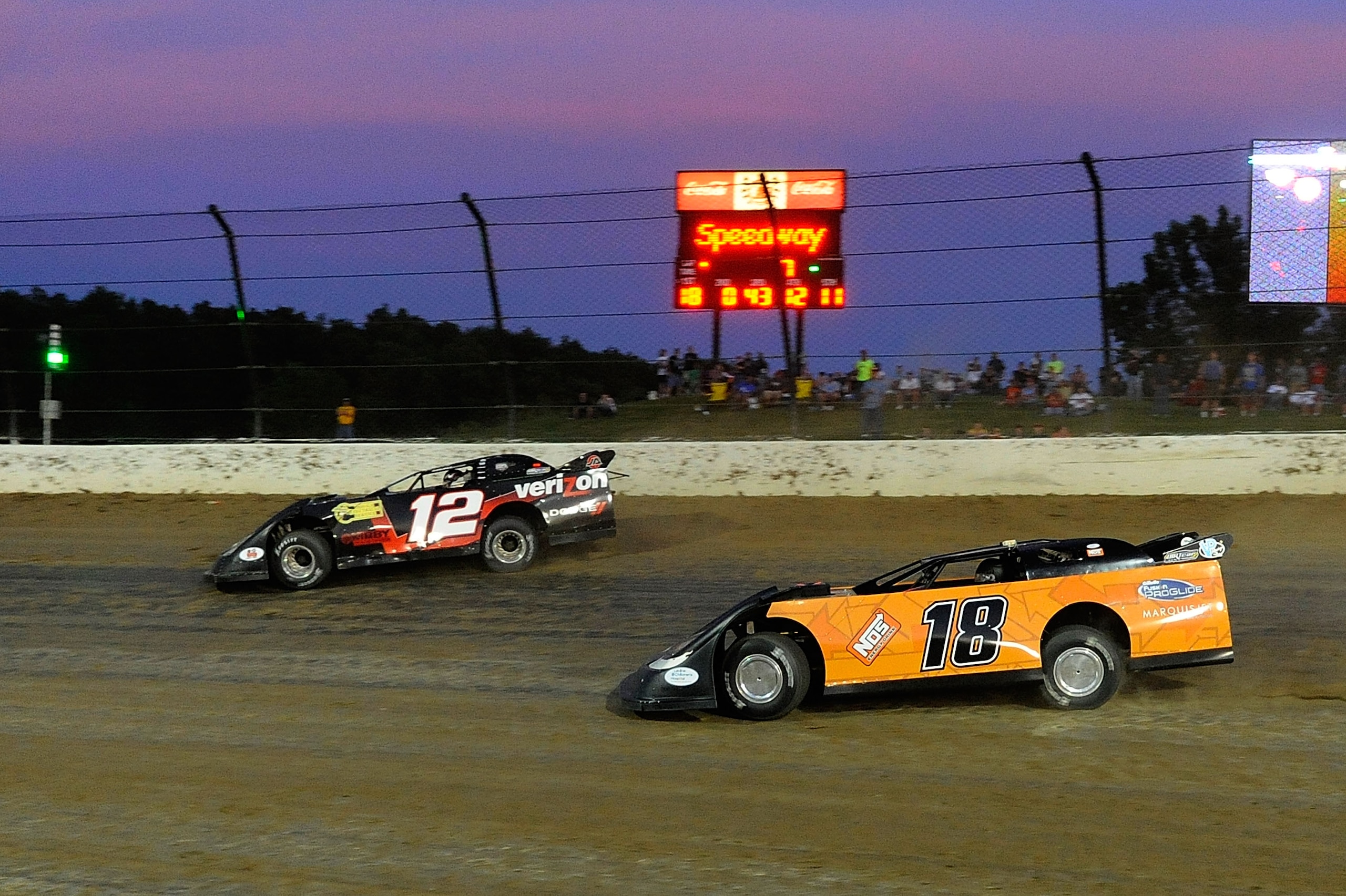ROSSBURG, OH - JUNE 09: Justin Allgaier, driver of the #12 Verizon Wireless late model Dodge, races with Kyle Busch, driver of the #18 NOS Energy late model Toyota, during the Gillette Fusion ProGlide Prelude to the Dream at Eldora Speedway on June 9, 201