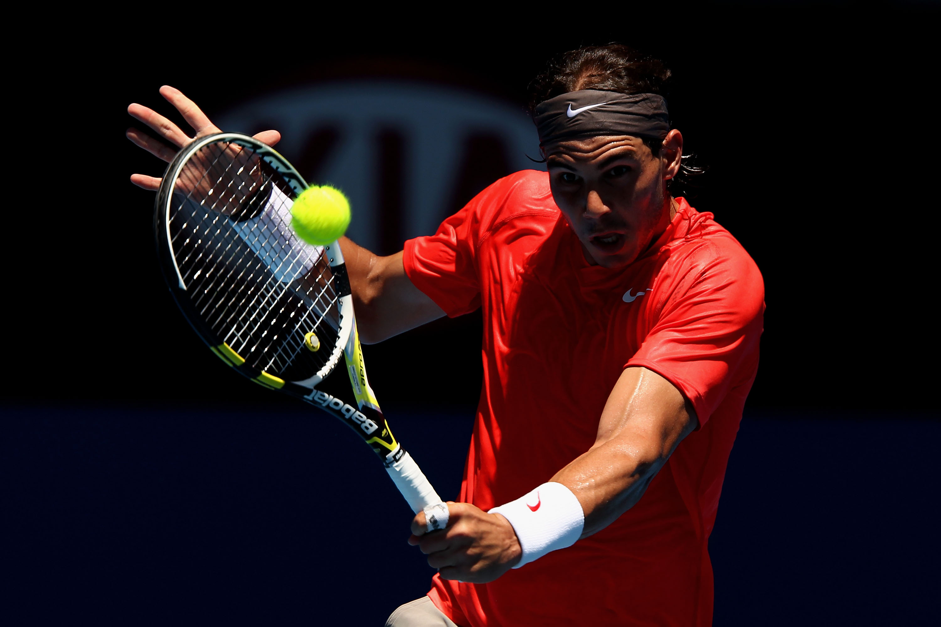 MELBOURNE, AUSTRALIA - JANUARY 20:  Rafael Nadal of Spain plays a backhand in his second round match against Ryan Sweeting of the United States of America during day four of the 2011 Australian Open at Melbourne Park on January 20, 2011 in Melbourne, Aust