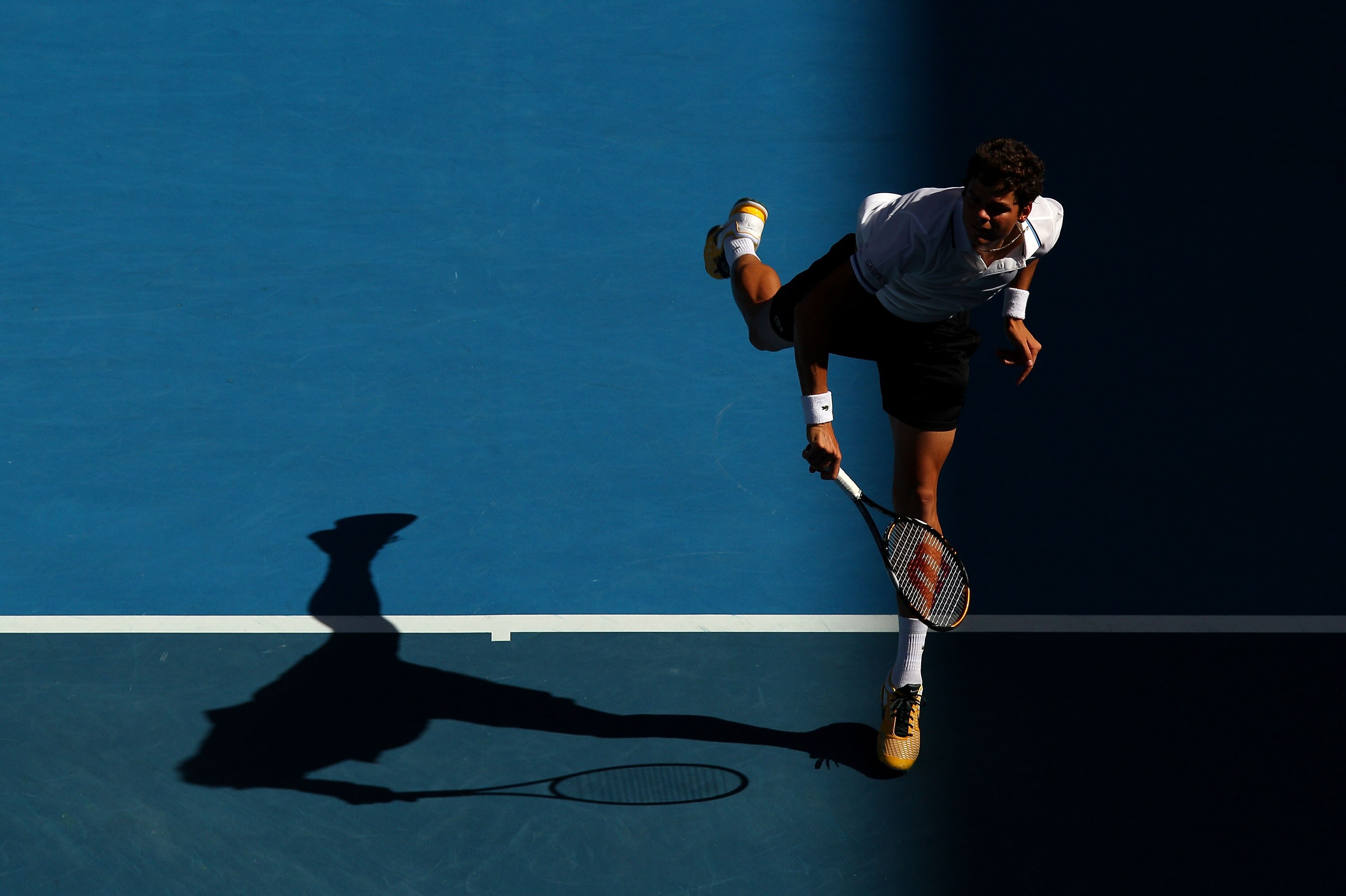 MELBOURNE, AUSTRALIA - JANUARY 24:  Milos Raonic of Canada serves in his fourth round match against David Ferrer of Spain during day eight of the 2011 Australian Open at Melbourne Park on January 24, 2011 in Melbourne, Australia.  (Photo by Mark Dadswell/