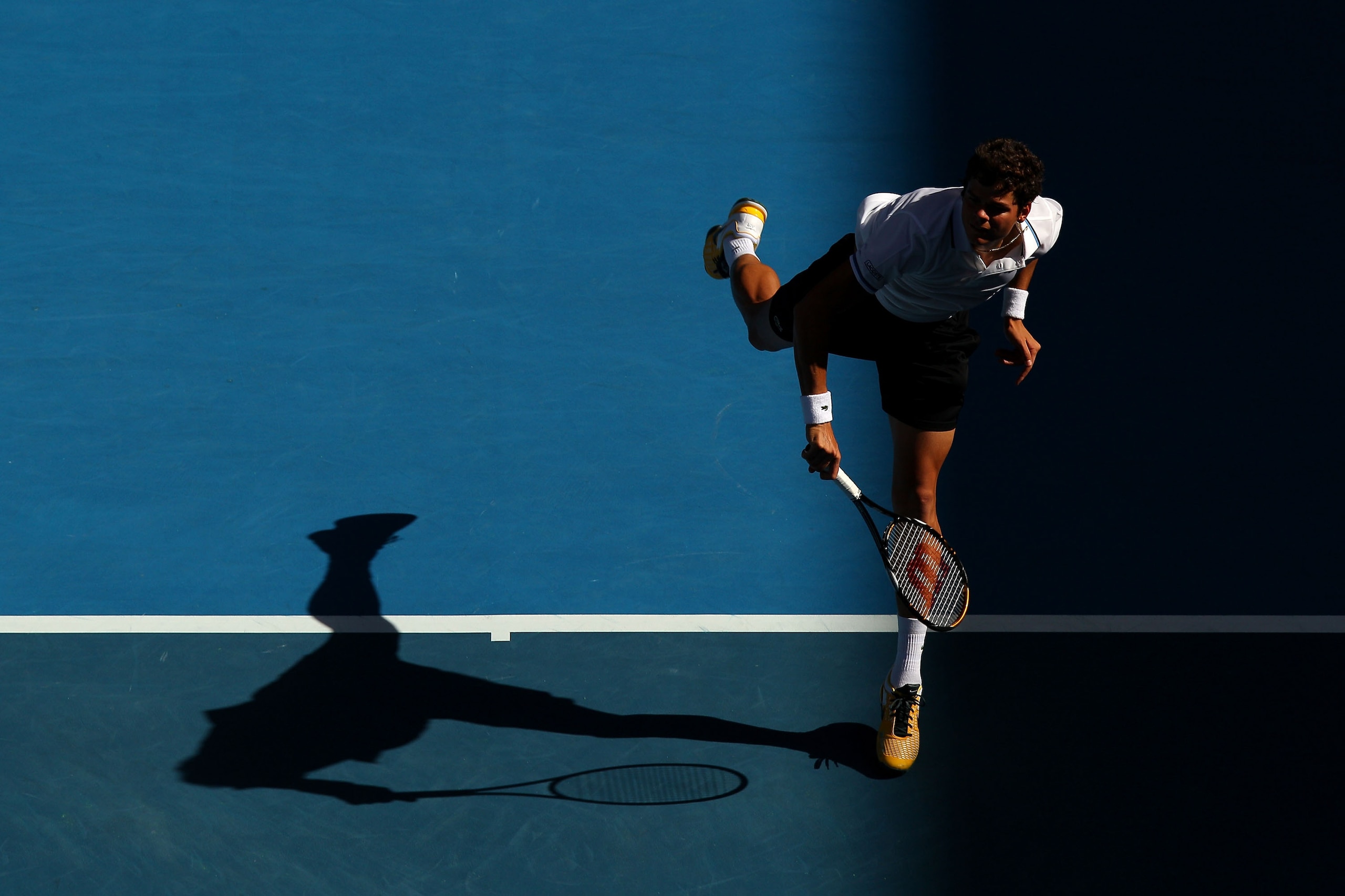 MELBOURNE, AUSTRALIA - JANUARY 24:  Milos Raonic of Canada serves in his fourth round match against David Ferrer of Spain during day eight of the 2011 Australian Open at Melbourne Park on January 24, 2011 in Melbourne, Australia.  (Photo by Mark Dadswell/