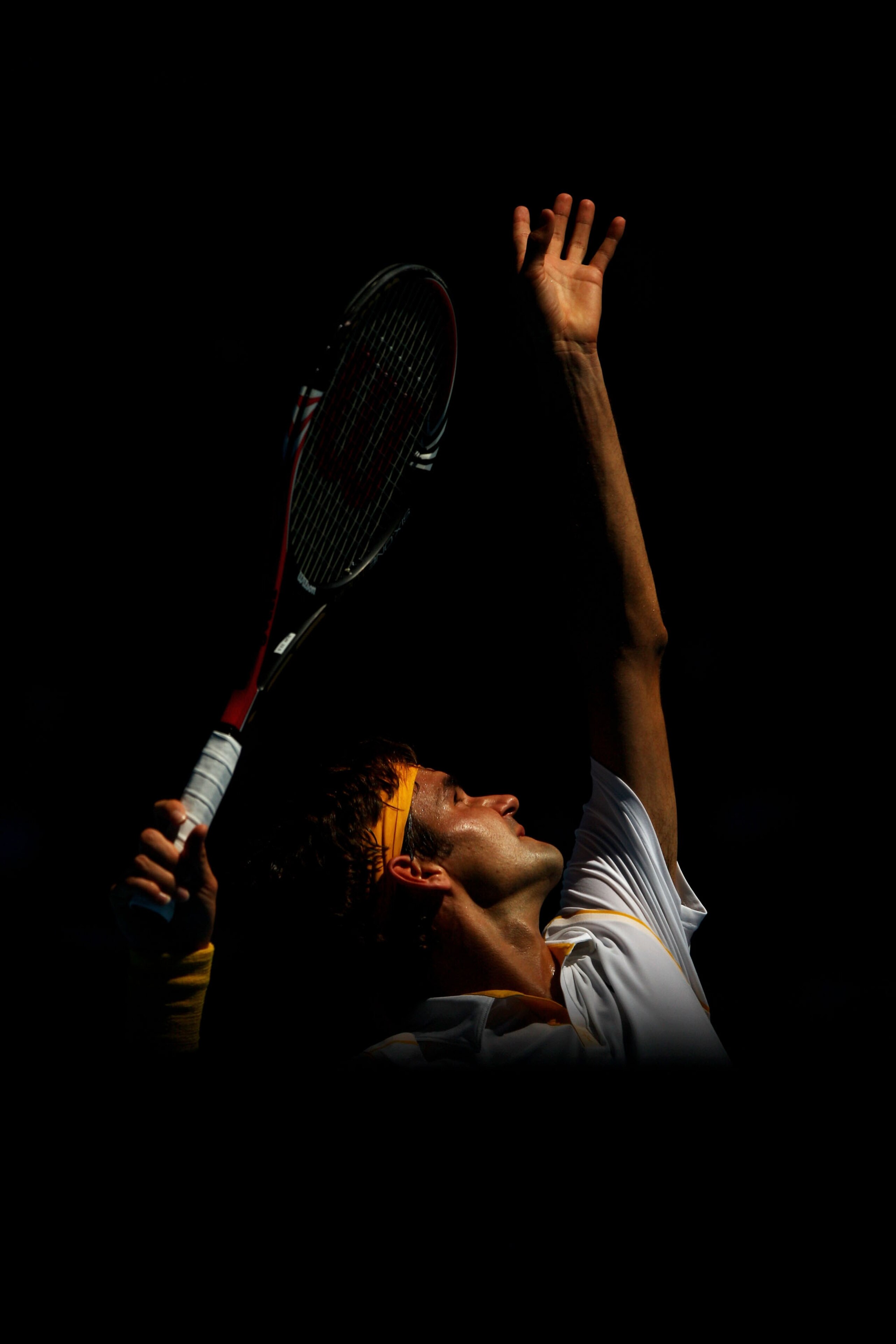 MELBOURNE, AUSTRALIA - JANUARY 23:  Roger Federer of Switzerland serves in his fourth round match against Tommy Robredo of Spain during day seven of the 2011 Australian Open at Melbourne Park on January 23, 2011 in Melbourne, Australia.  (Photo by Quinn R