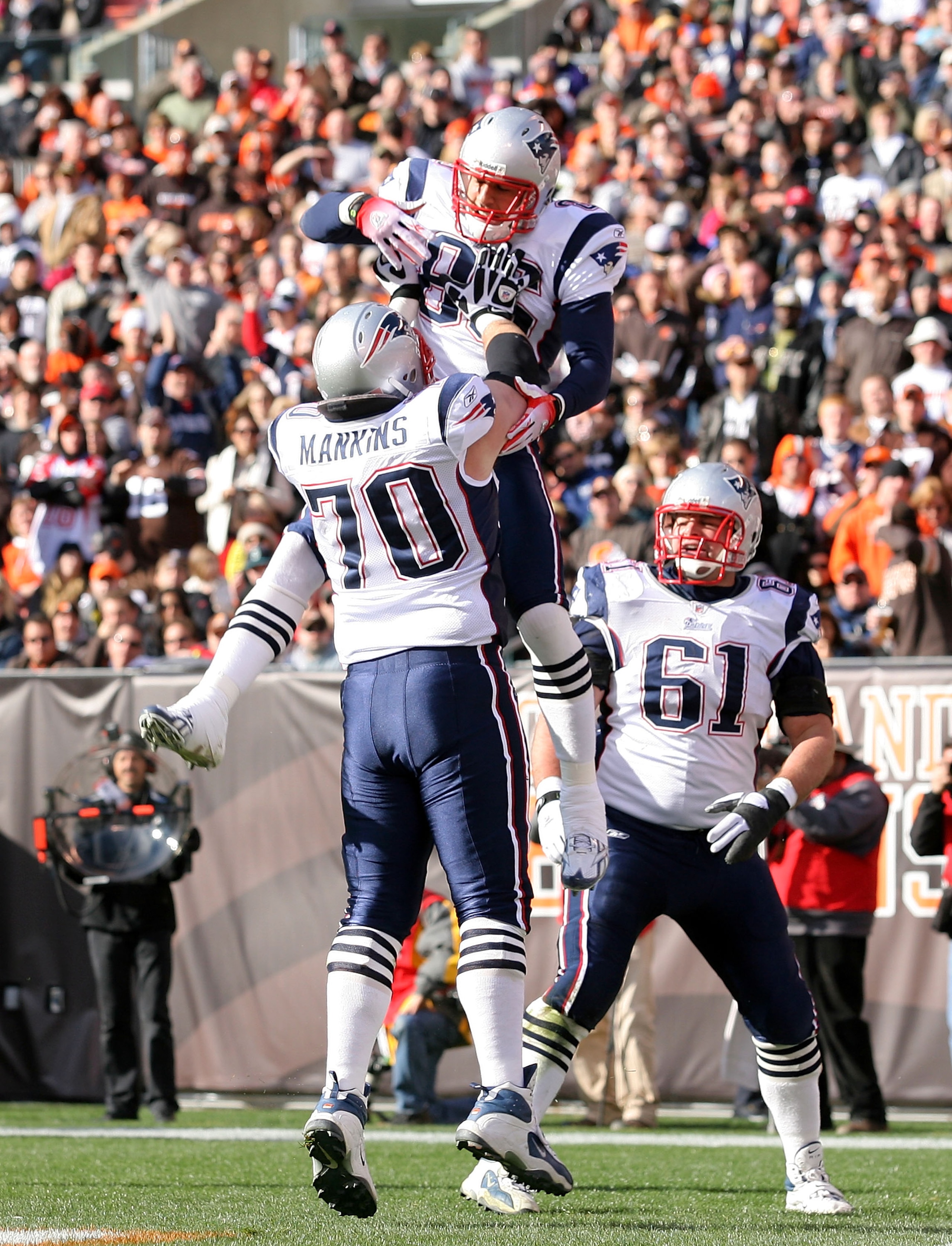 CLEVELAND - NOVEMBER 07:  Tight end Aaron Hernandez #85 of the New England Patriots celebrates with Logan Mankins #70 and Stephen Neal #61 after scoring a touchdown against the Cleveland Browns at Cleveland Browns Stadium on November 7, 2010 in Cleveland,