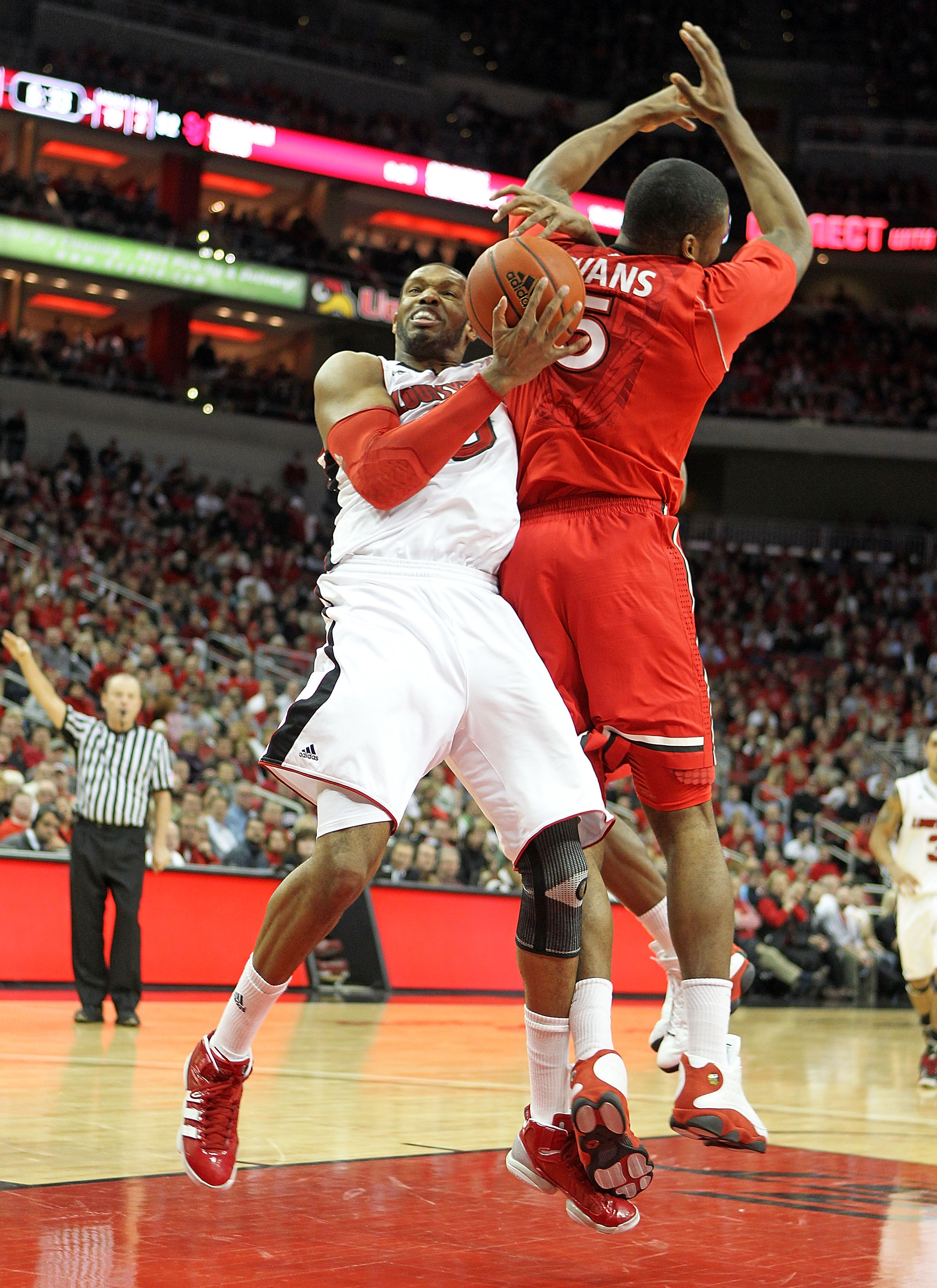 LOUISVILLE, KY - JANUARY 19: George Goode #0 of the Louisville Cardinals and Sean Evans #5 of the St. John's Red Storm battle for a rebound during the Big East Conference game at the KFC Yum! Center on January 19, 2011 in Louisville, Kentucky. Louisville