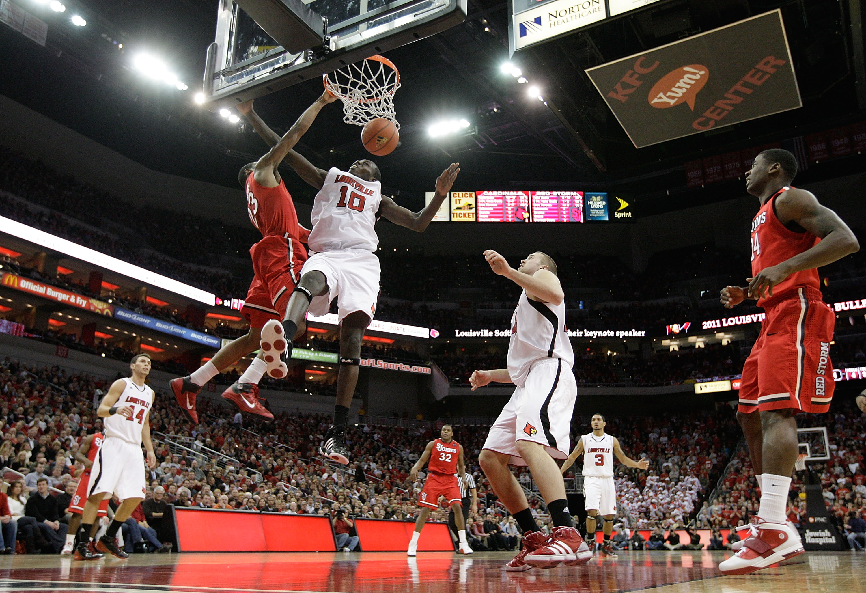 LOUISVILLE, KY - JANUARY 19: Paris Horne #23 of the St. John's Red Storm dunks the ball while defended by Gorgui Deng #10 of the Louisville Cardinals during the Big East Conference game at the KFC Yum! Center on January 19, 2011 in Louisville, Kentucky