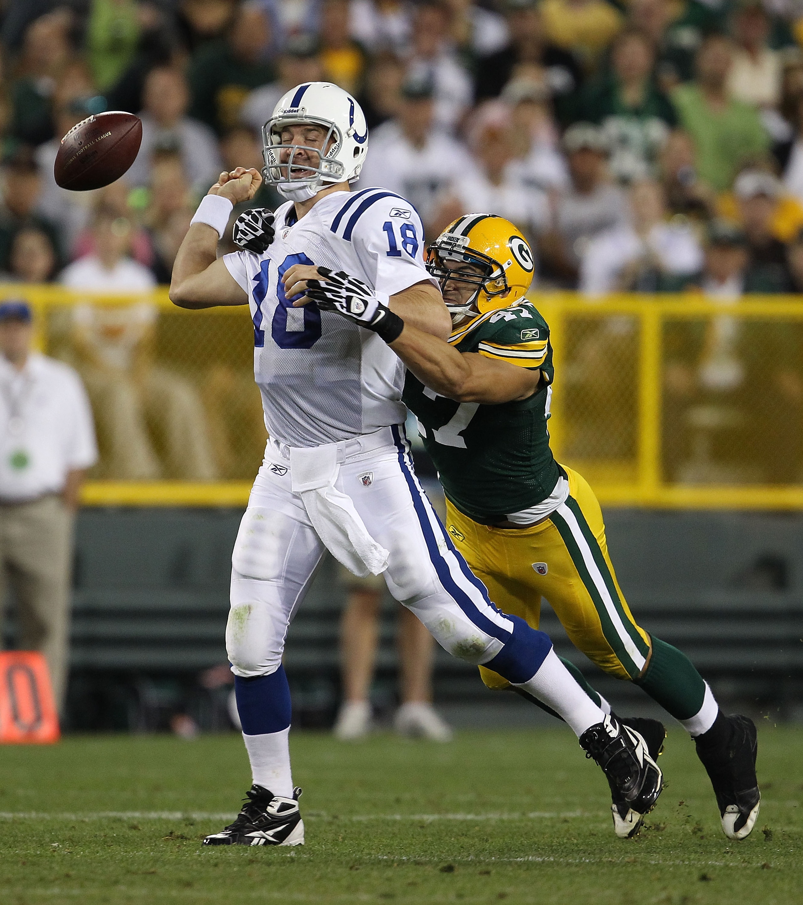 GREEN BAY, WI - AUGUST 26: Peyton Manning #18 of the Indianapolis Colts fumbles the ball as he is hit by Frank Zombo #47 of the Green Bay Packers during a preseason game at Lambeau Field on August 26, 2010 in Green Bay, Wisconsin. (Photo by Jonathan Danie