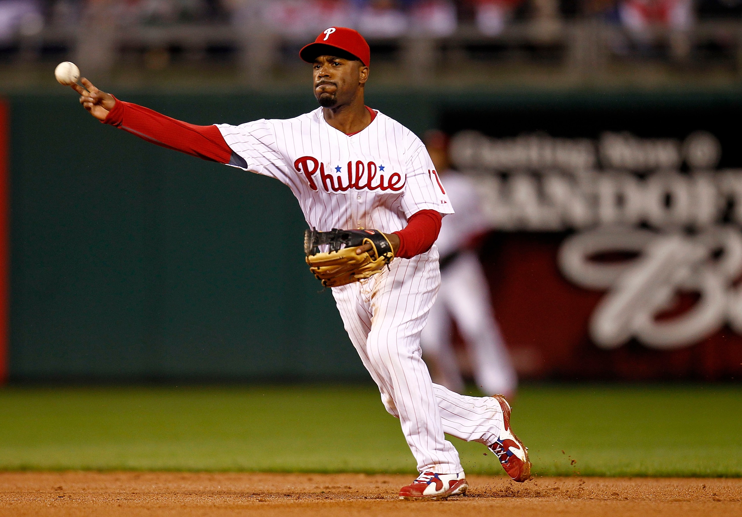 PHILADELPHIA - OCTOBER 06:  Jimmy Rollins #11 of the Philadelphia Phillies throws to first in Game 1 of the NLDS against the Cincinnati Reds at Citizens Bank Park on October 6, 2010 in Philadelphia, Pennsylvania.  (Photo by Jeff Zelevansky/Getty Images)