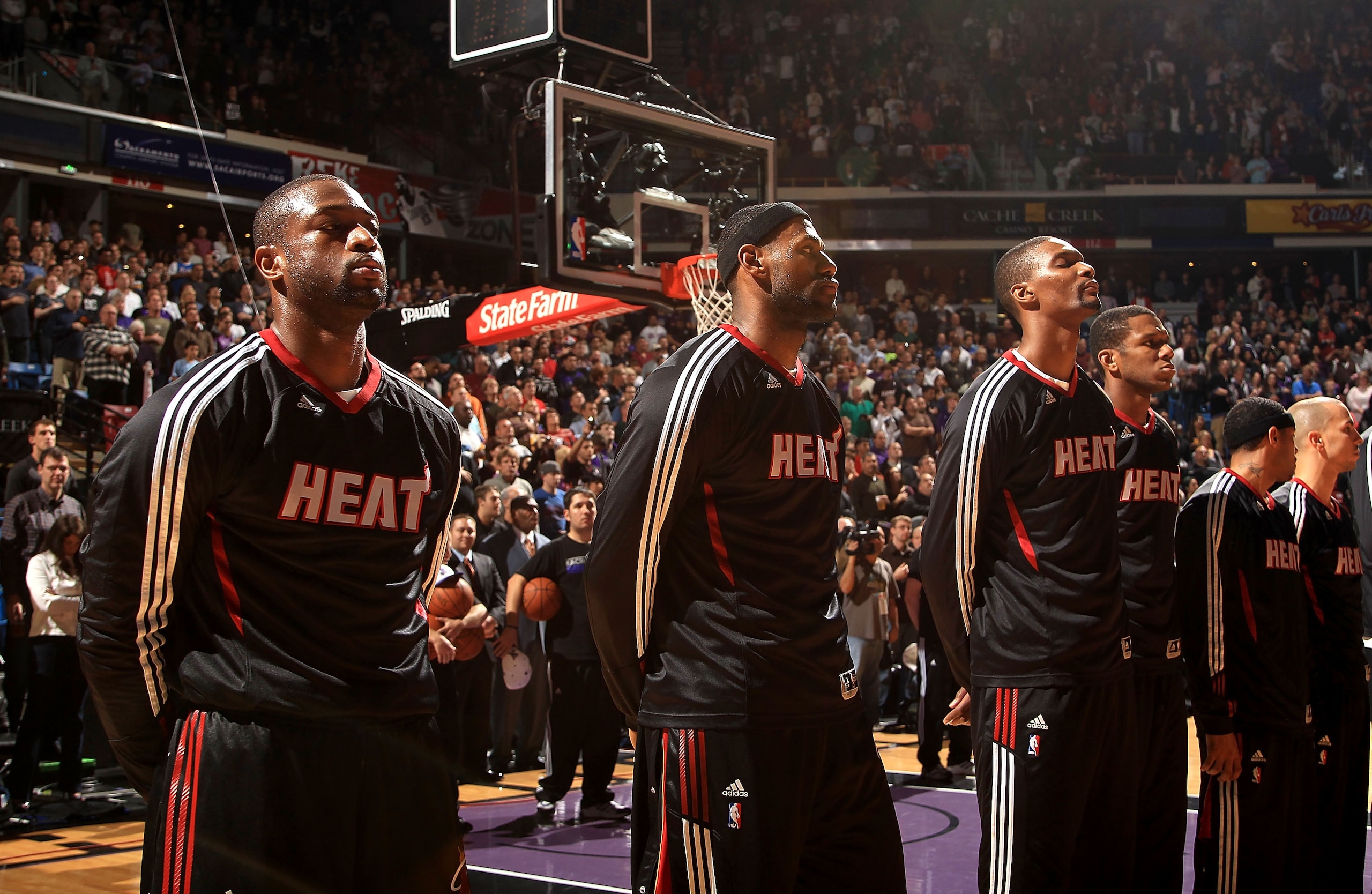 SACRAMENTO, CA - DECEMBER 11: Dwyane Wade #3, LeBron James #6 and Chris Bosh #1 of the Miami Heat stand for the National Anthem before their game against the Sacramento Kings at ARCO Arena on December 11, 2010 in Sacramento, California. NOTE TO USER: User