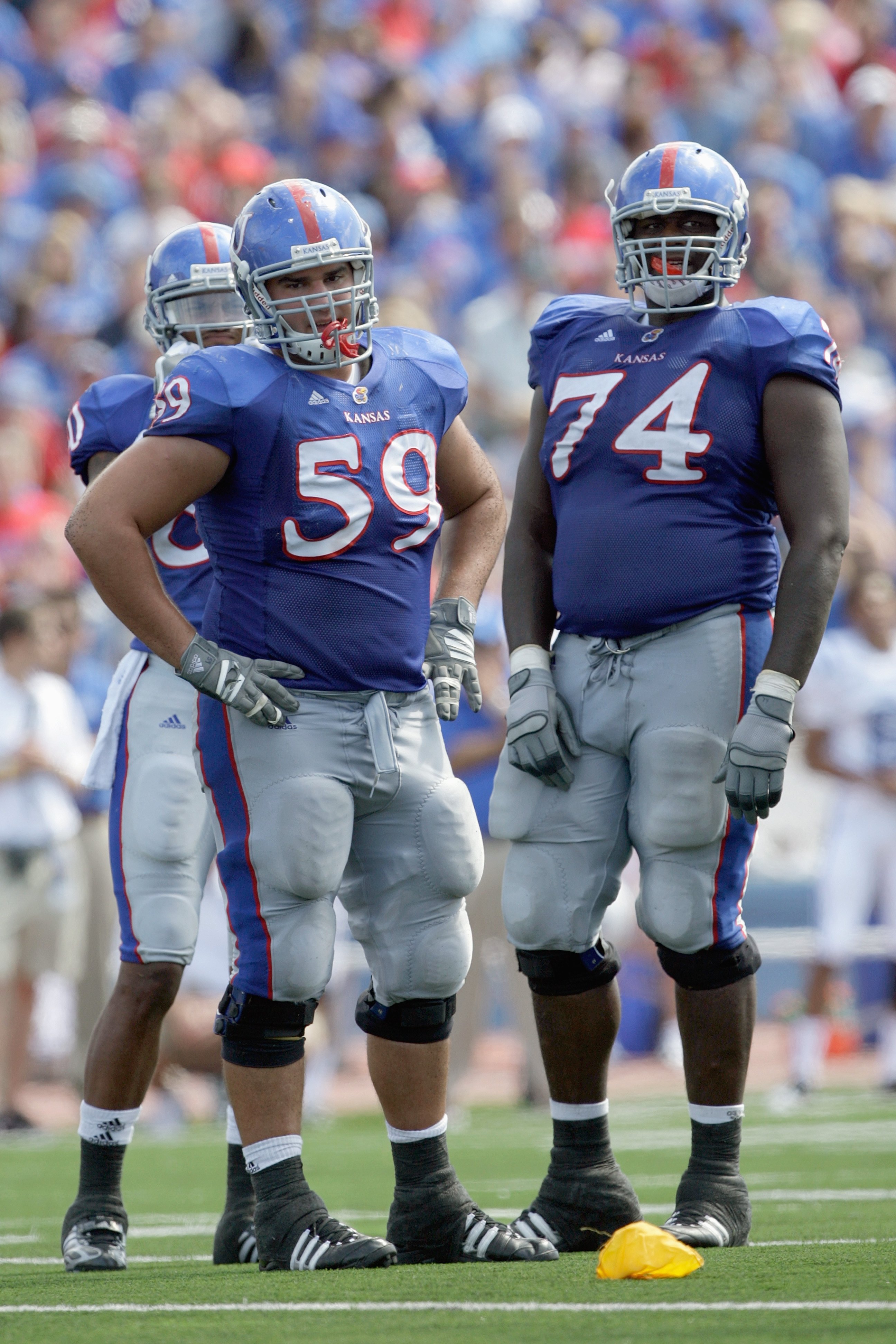 LAWRENCE, KS - SEPTEMBER 19: Offensive linemen Sal Capra #59 and Jeff Spikes #74of the Kansas Jayhawks look on the field during the game against the Duke Blue Devils on Kivisto Field at Memorial Stadium on September 19, 2009 in Lawrence, Kansas. (Photo by