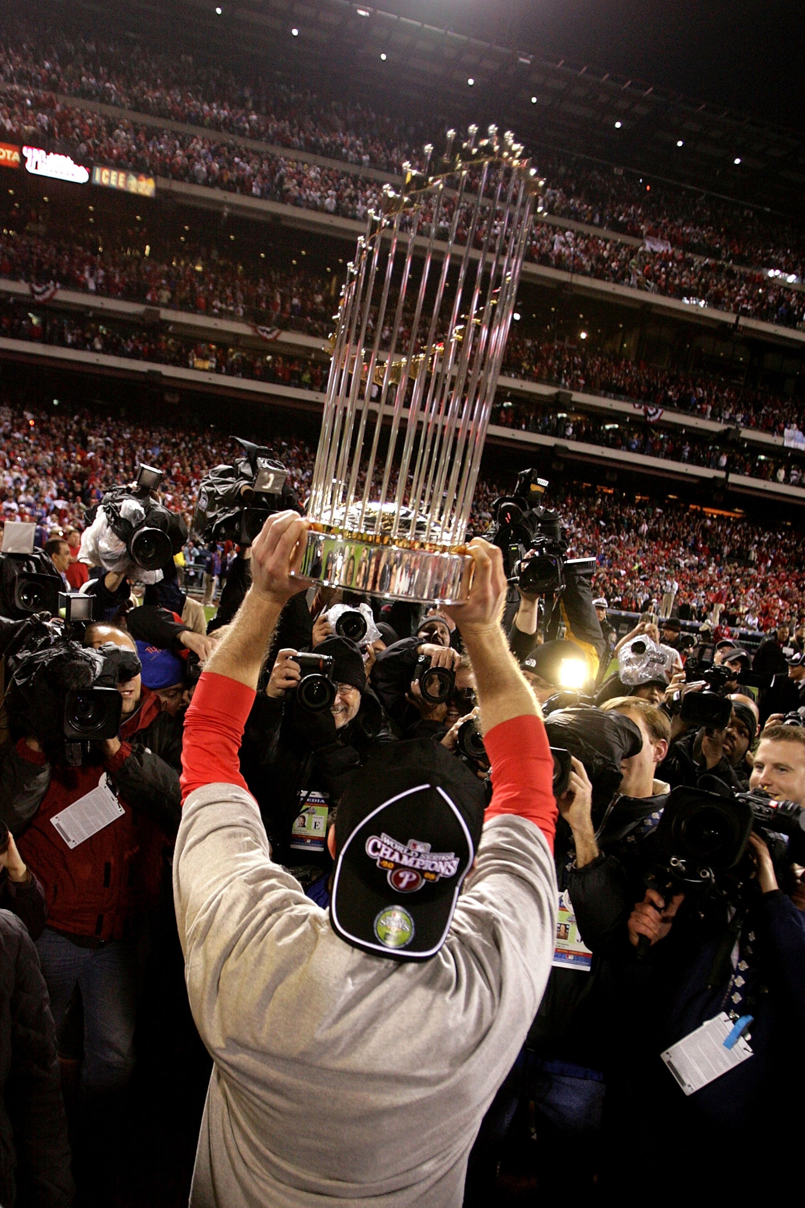 PHILADELPHIA - OCTOBER 29:  Chase Utley #26 of the Philadelphia Phillies celebrates on the field with the World Series Championship trophy after their 4-3 win against the Tampa Bay Rays during the continuation of game five of the 2008 MLB World Series on