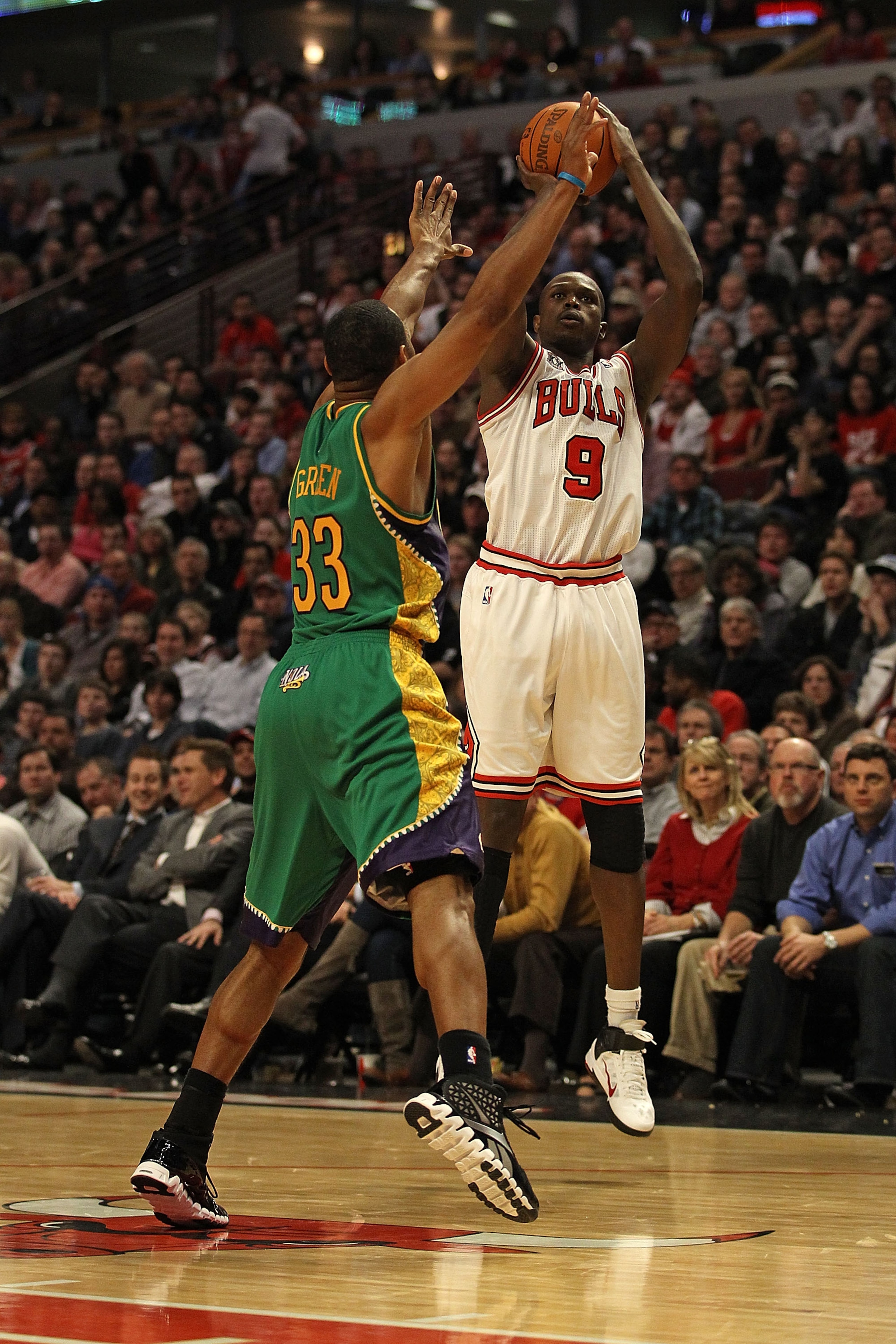 CHICAGO, IL - MARCH 07: Loul Deng #9 of the Chicago Bulls puts up a shot over Willie Green #33 of the New Orleans Hornets at the United Center on March 7, 2011 in Chicago, Illinois. The Bulls defeated the Hornets 85-77. NOTE TO USER: User expressly acknow