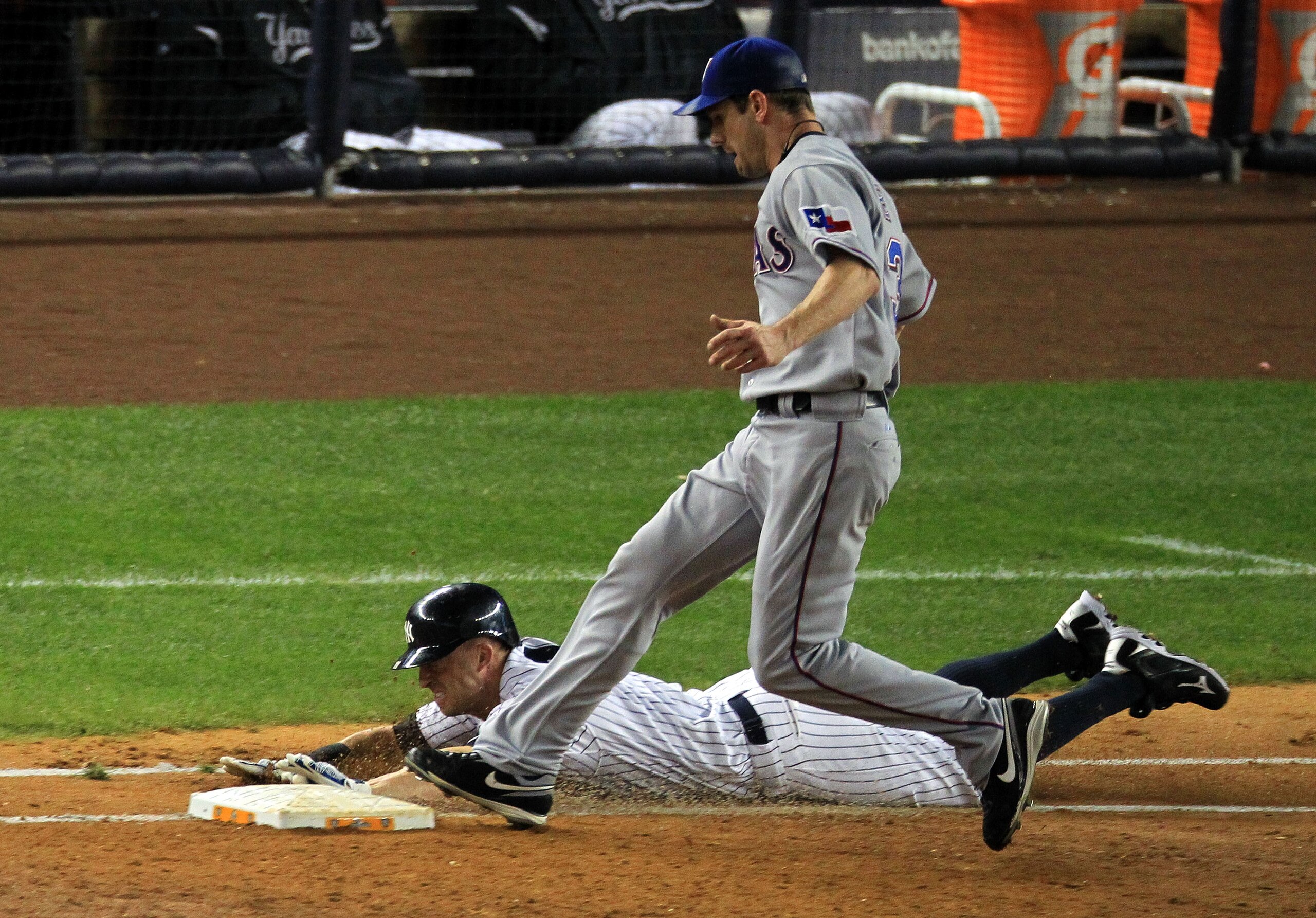 NEW YORK - OCTOBER 18:  Brett Gardner #11 of the New York Yankees is forced out at first base by pitcher Cliff Lee #33 of the Texas Rangers in the bottom of the third inning of Game Three of the ALCS during the 2010 MLB Playoffs at Yankee Stadium on Octob