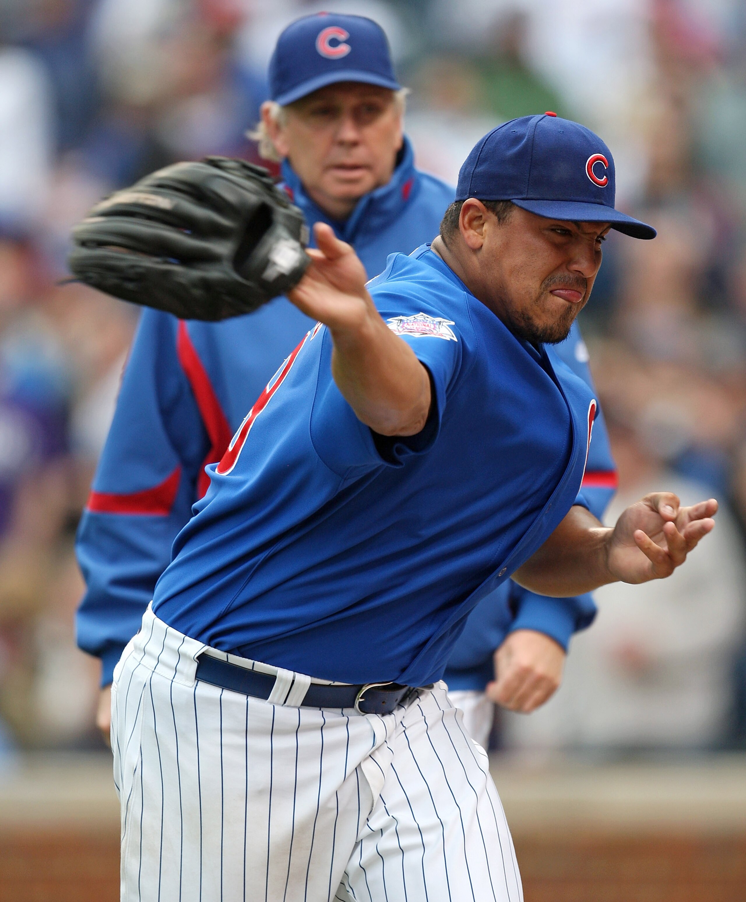 CHICAGO - MAY 27: Starting pitcher Carlos Zambrano #38 of the Chicago Cubs throws his glove into the dugout after being thrown out of a game in the 7th inning against the Pittsburgh Pirates as pitching coach Larry Rothschild watches on May 27, 2009 at Wri