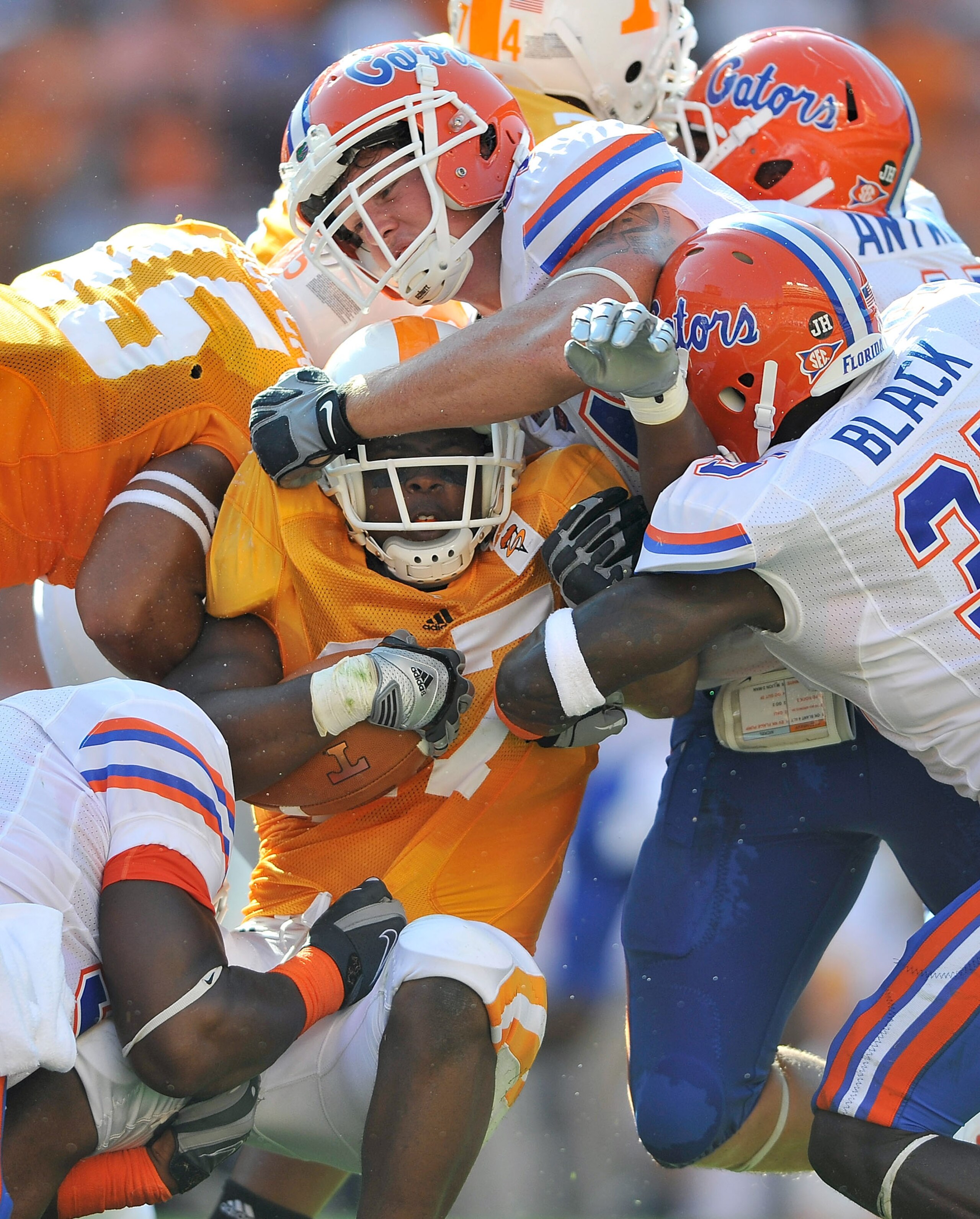 KNOXVILLE, TN - SEPTEMBER 18:  The Florida Gators defense smothers David Oku #27 of the Tennessee Volunteers at Neyland Stadium on September 18, 2010 in Knoxville, Tennessee.  (Photo by Grant Halverson/Getty Images)
