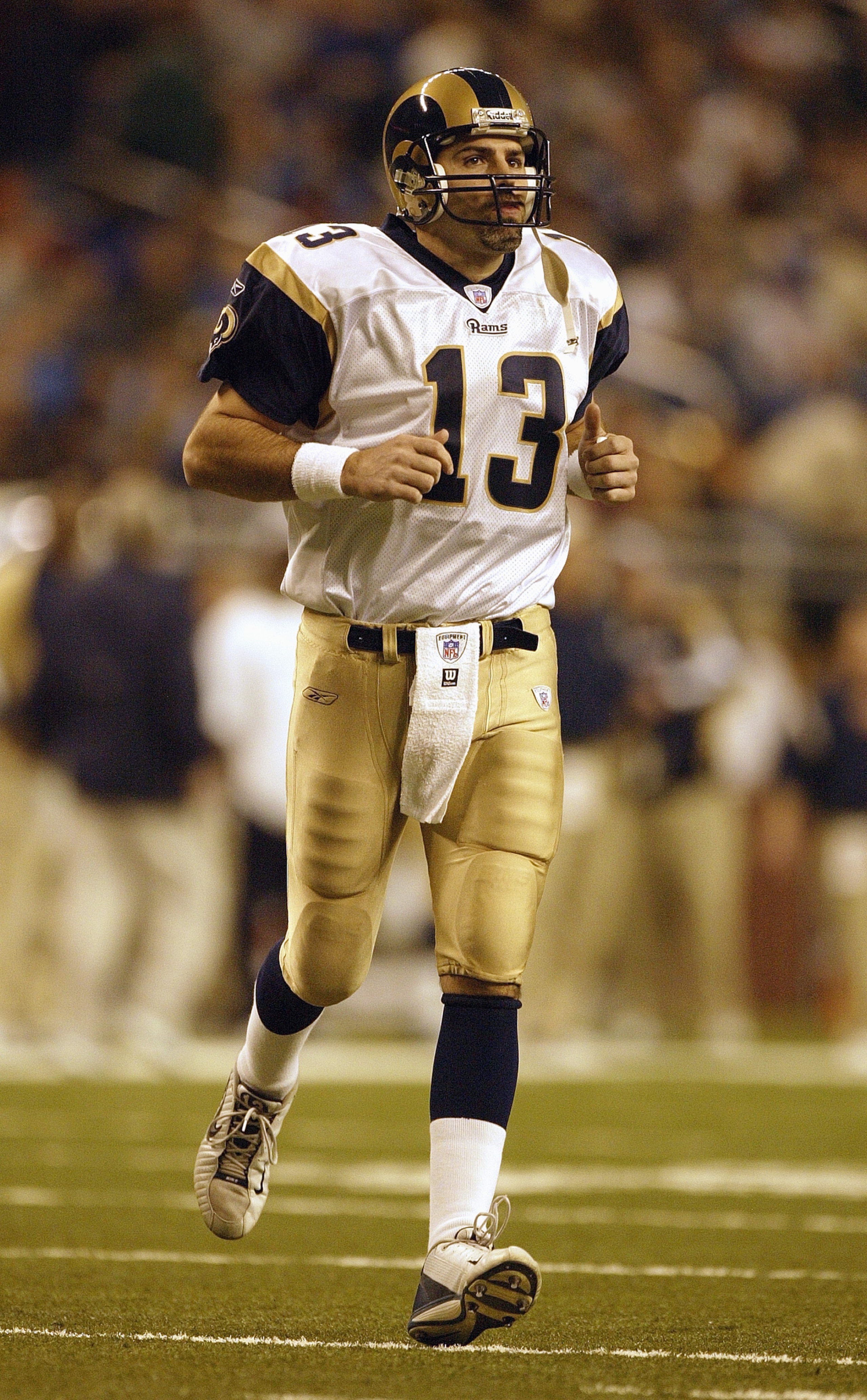 DETROIT - DECEMBER 28:  Quarterback Kurt Warner #13 of the St. Louis Rams runs on the field during the game against the Detroit Lions on December 28, 2003 at Ford Field in Detroit, Michigan. The Lions upset the Rams 30-20. (Photo by Harry How/Getty Images