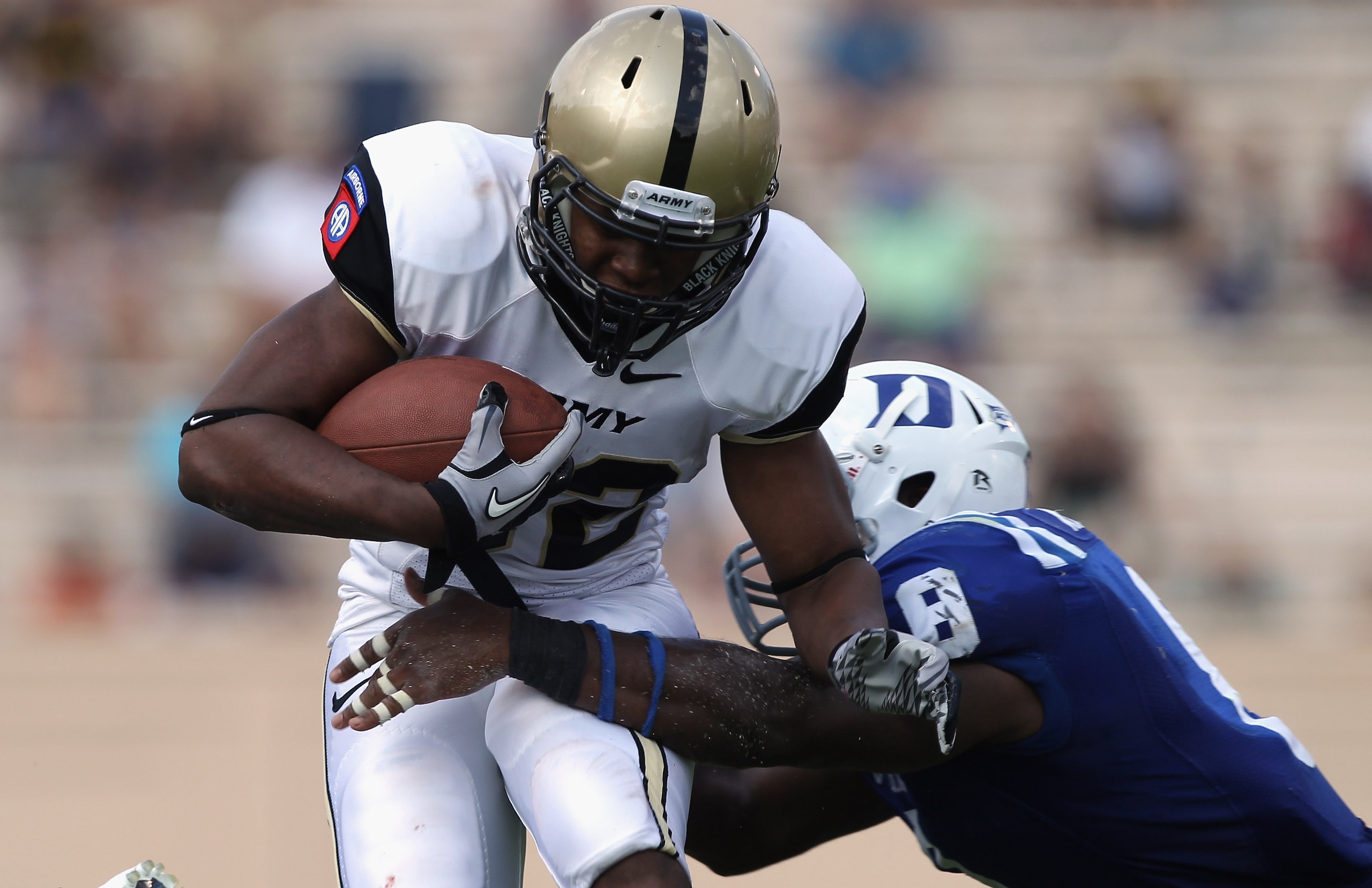DURHAM, NC - SEPTEMBER 25:  Brian Cobbs #32 of the Army Black Knights is tackled by Abraham Kromah #8 of the Duke Blue Devils at Wallace Wade Stadium on September 25, 2010 in Durham, North Carolina.  (Photo by Streeter Lecka/Getty Images)