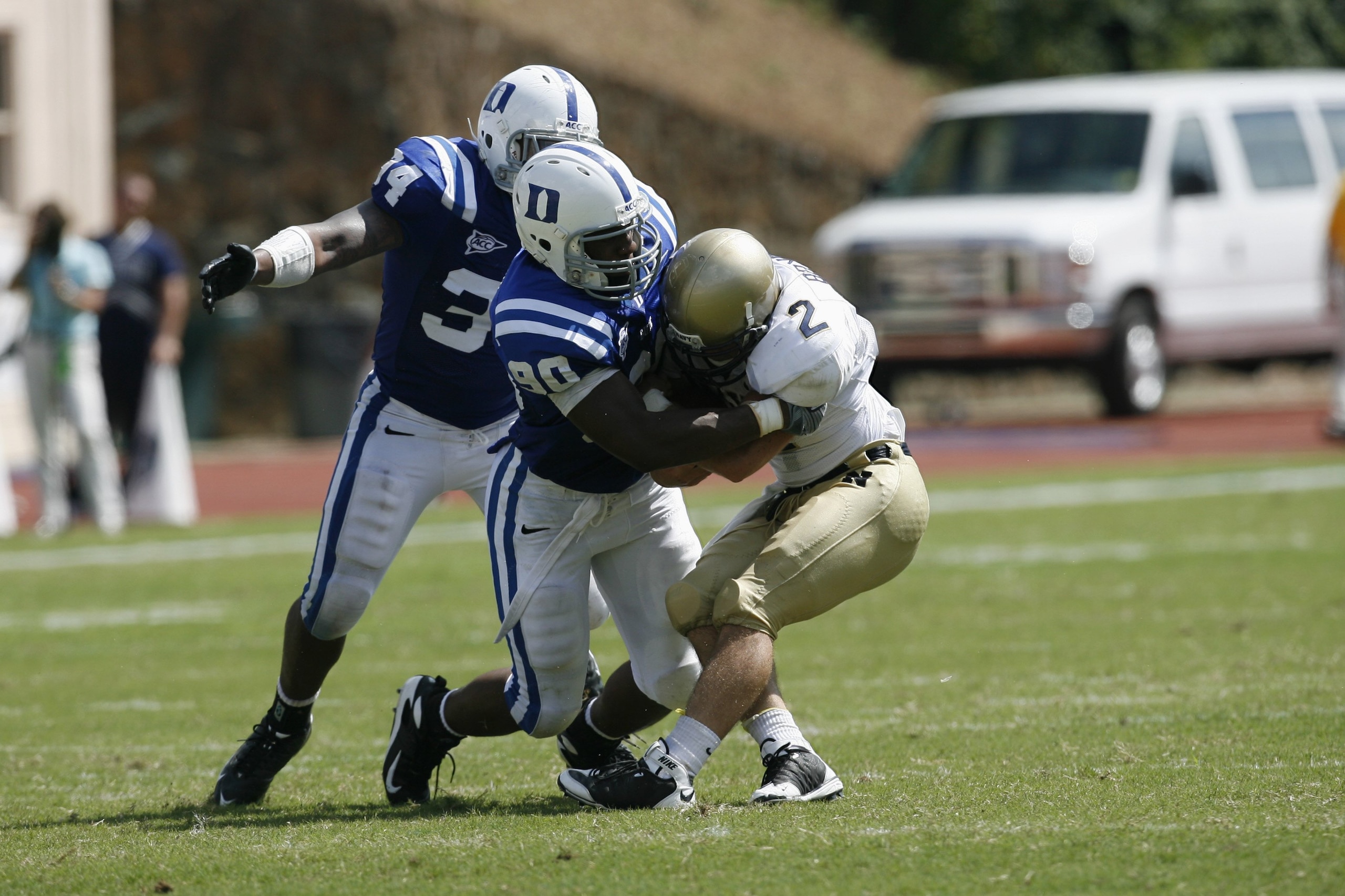 DURHAM, NC - SEPTEMBER 13:  Patrick Egboh #90 of the Duke Blue Devils tackles Jarod Bryant #2 of the Navy Midshipmen during the game at Wallace Wade Stadium on September 13, 2008 in Durham, North Carolina.  (Photo by Kevin C. Cox/Getty Images)