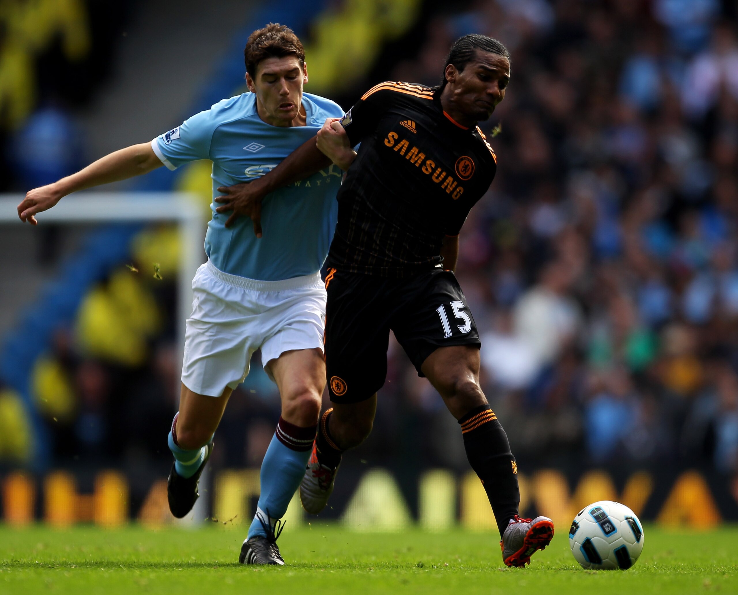 MANCHESTER, ENGLAND - SEPTEMBER 25:  Florent Malouda of Chelsea battles for the ball with Gareth Barry of Manchester City during the Barclays Premier League match between Manchester City and Chelsea at the City of Manchester Stadium on September 25, 2010 