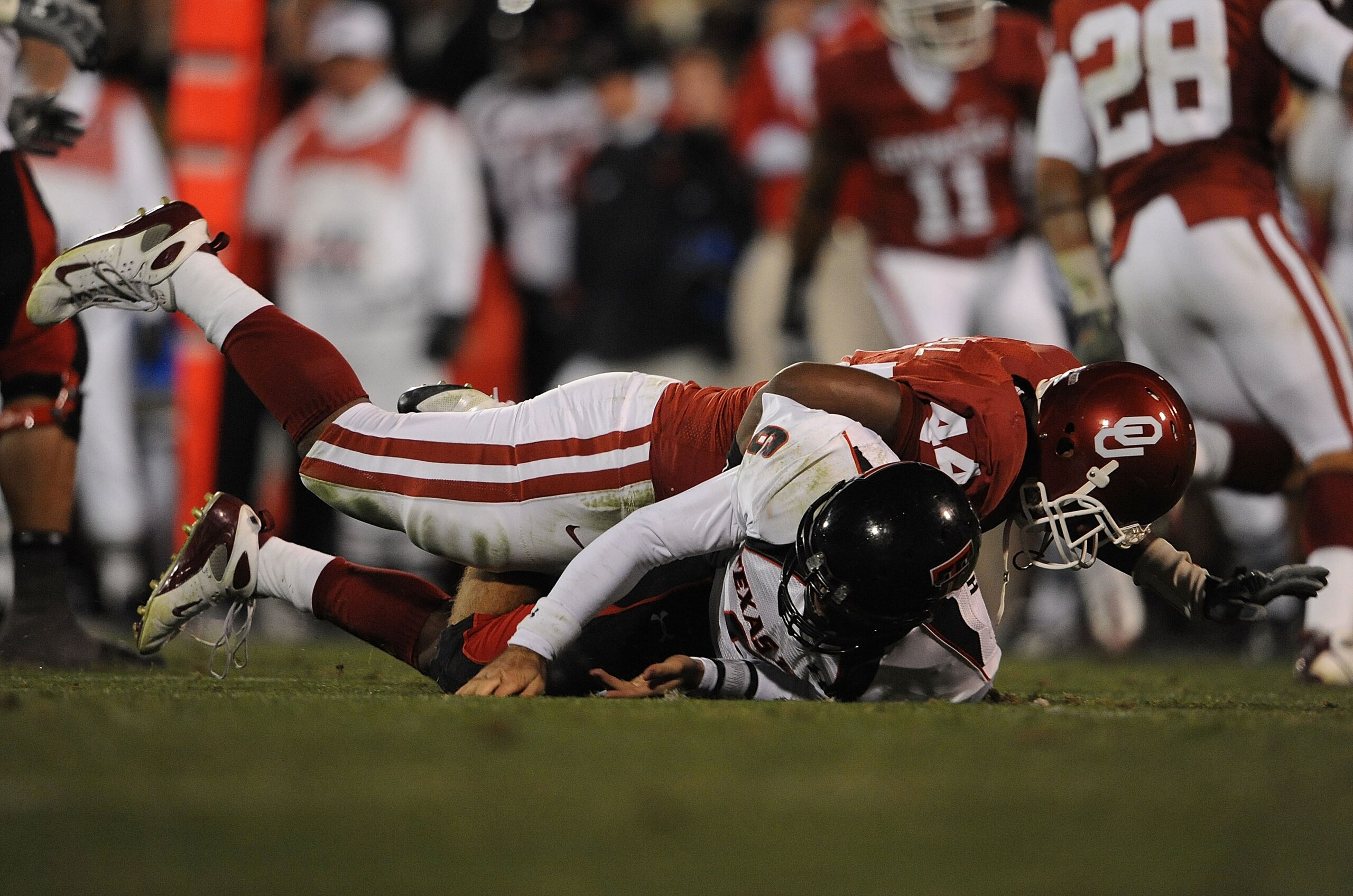 NORMAN, OK - NOVEMBER 22:  Quarterback Graham Harrell #6 of the Texas Tech Red Raiders is tackled by Jeremy Beal #44 of the Oklahoma Sooners at Memorial Stadium on November 22, 2008 in Norman, Oklahoma.  (Photo by Ronald Martinez/Getty Images)