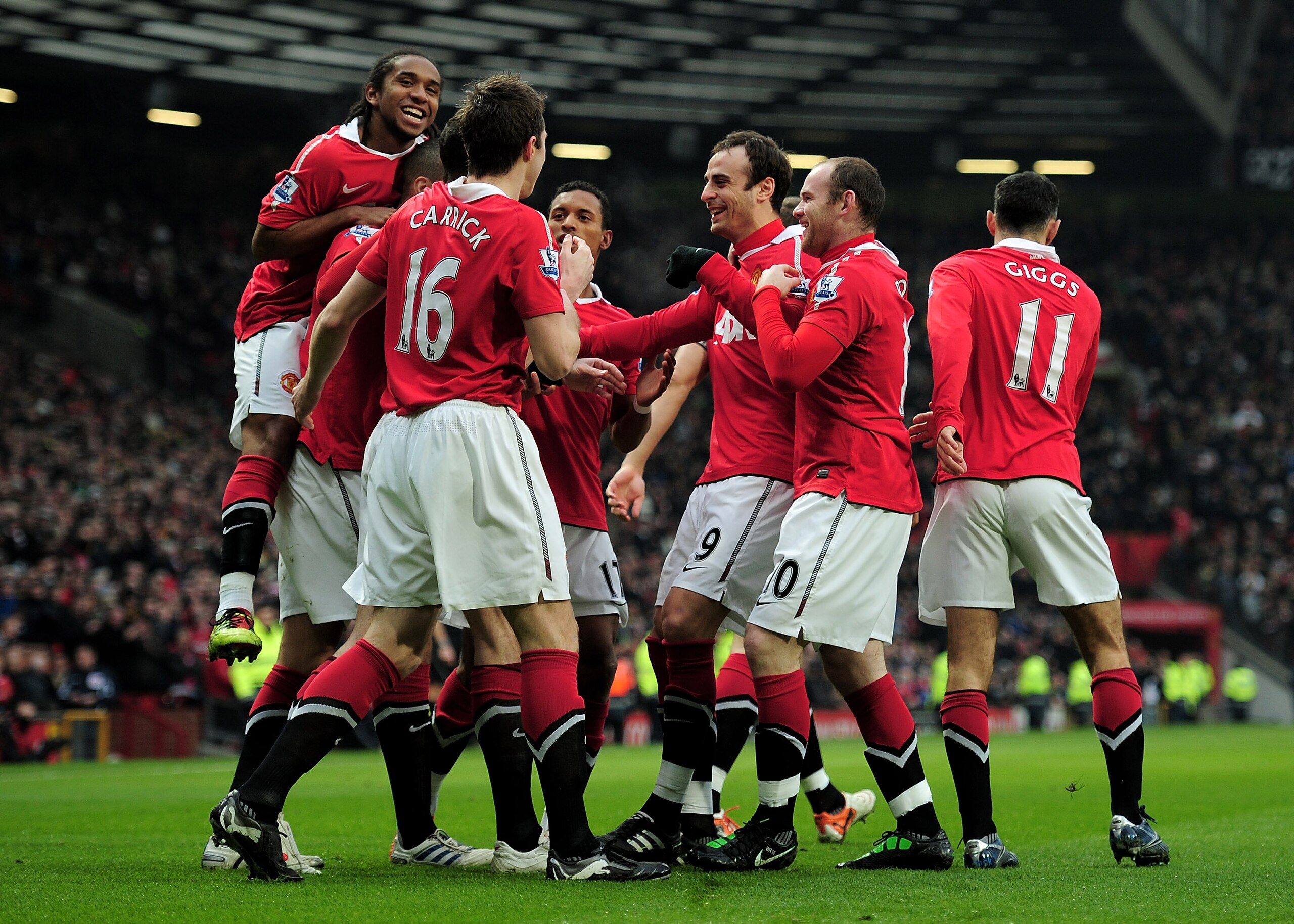 MANCHESTER, ENGLAND - JANUARY 22:  Dimitar Berbatov of Manchester United celebrates with his team mates after scoring the opening goal during the Barclays Premier League match between Manchester United and Birmingham City at Old Trafford on January 22, 20