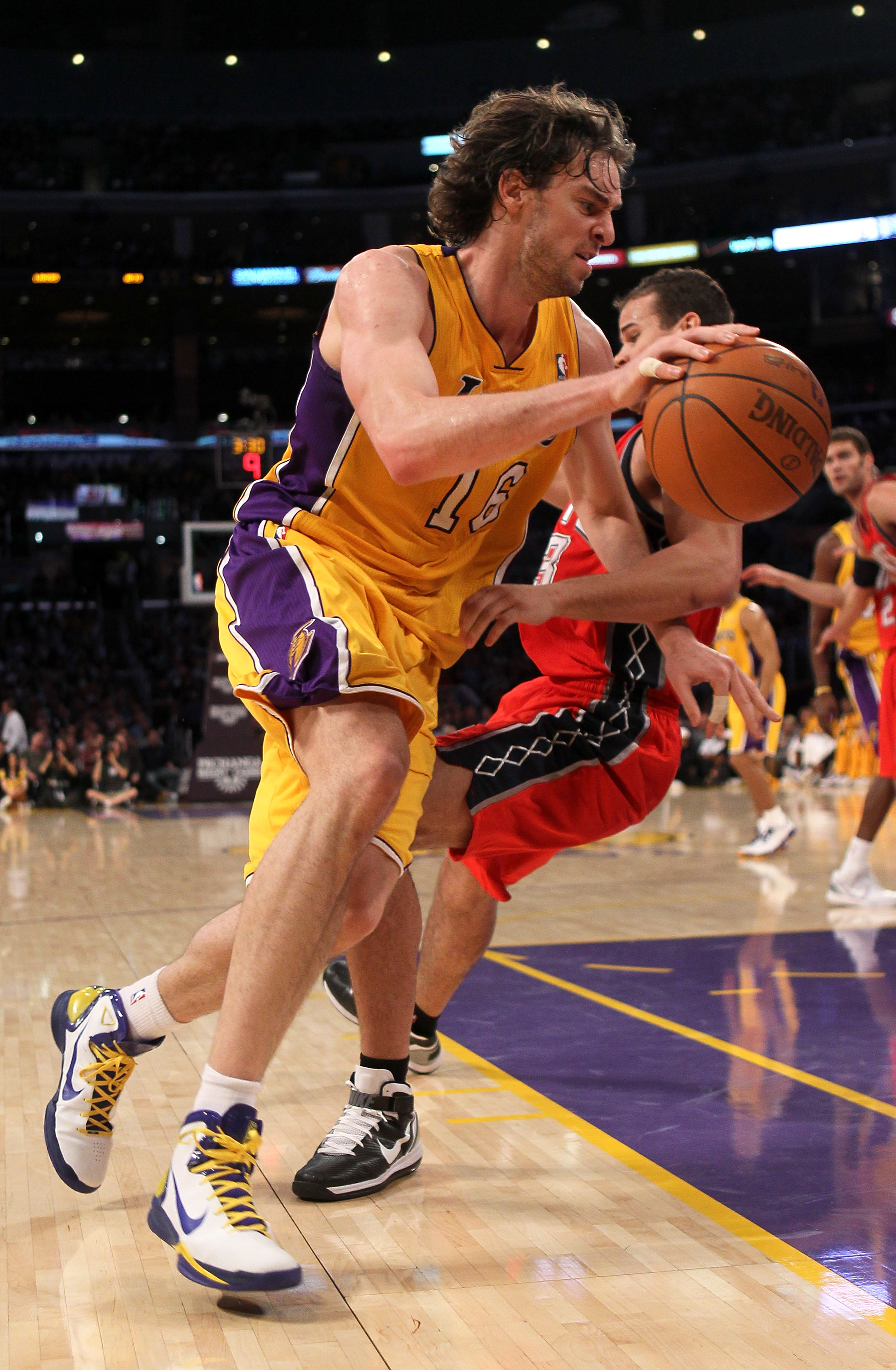 LOS ANGELES, CA - JANUARY 14:  Pau Gasol #16 of the Los Angeles Lakers shoots drives past Kris Humphries #43 of the New Jersey Nets at Staples Center on January 14, 2011 in Los Angeles, California. The Lakers won 100-88.  NOTE TO USER: User expressly ackn