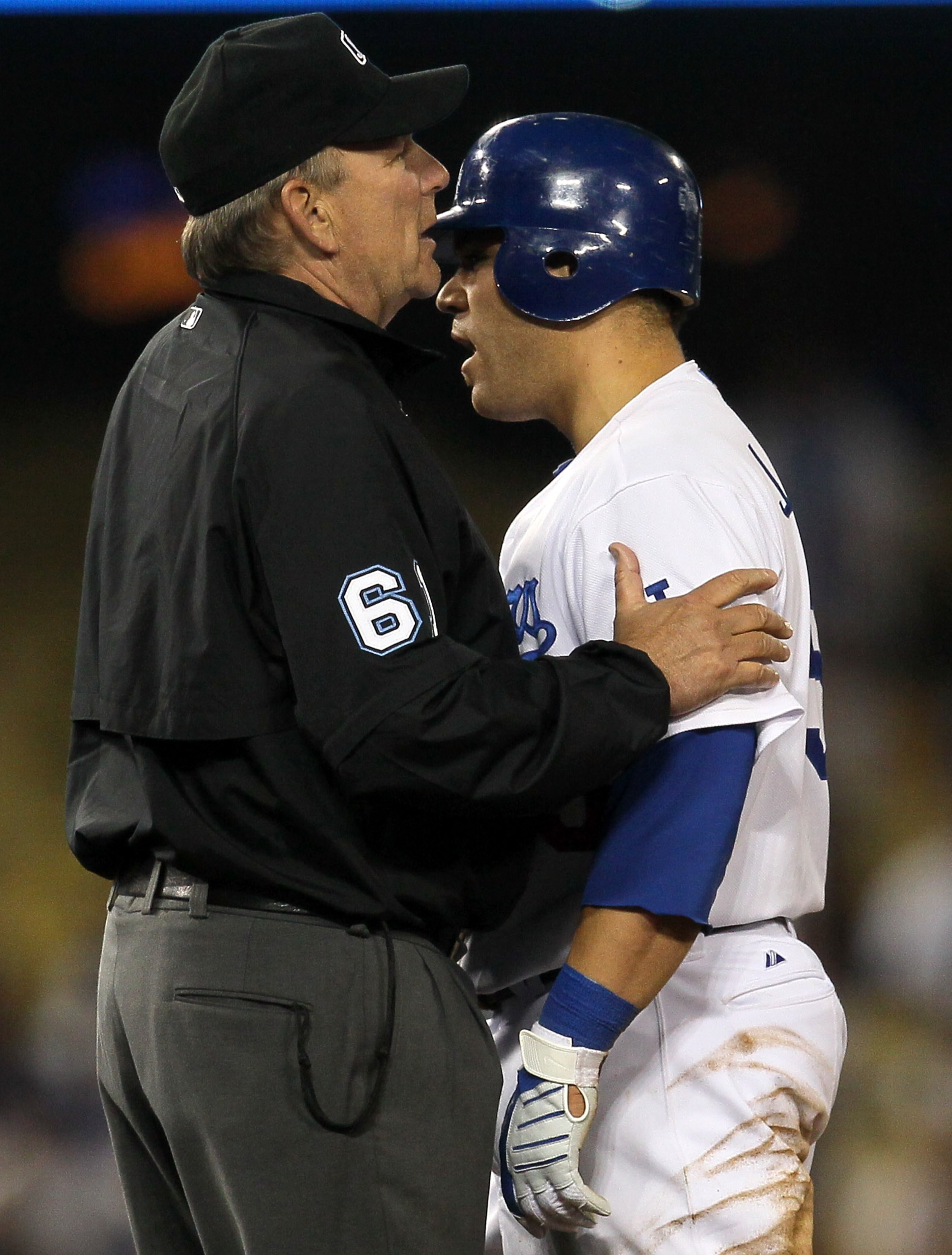 LOS ANGELES - JUNE 1: Russell Martin #55 of the Los Angeles Dodgers is restrained by umpire Bob Davidson as Martin has words with shortstop Stephen Drew of the Arizona Diamondbacks afer Martin was out in a play at second base on June 1, 2010 at Dodger Sta LOS ANGELES - JUNE 1: Russell Martin #55 of the Los Angeles Dodgers is restrained by umpire Bob Davidson as Martin has words with shortstop Stephen Drew of the Arizona Diamondbacks afer Martin was out in a play at second base on June 1, 2010 at Dodger Sta