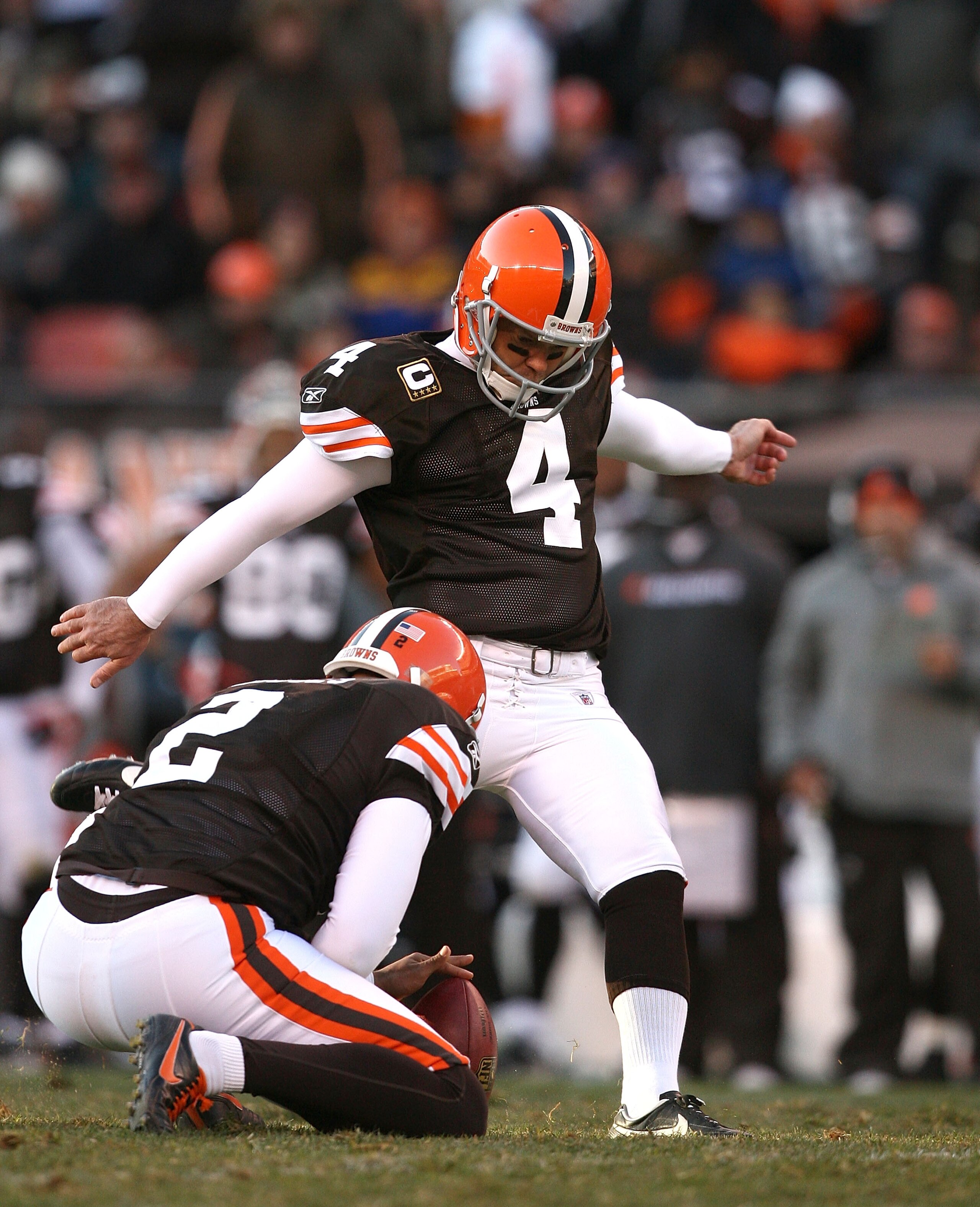 CLEVELAND - NOVEMBER 28:  Punter Reggie Hodges #2 holds as kicker Phil Dawson #4 of the Cleveland Browns kicks a fourth quarter field goal against the Carolina Panthers at Cleveland Browns Stadium on November 28, 2010 in Cleveland, Ohio.  (Photo by Matt S