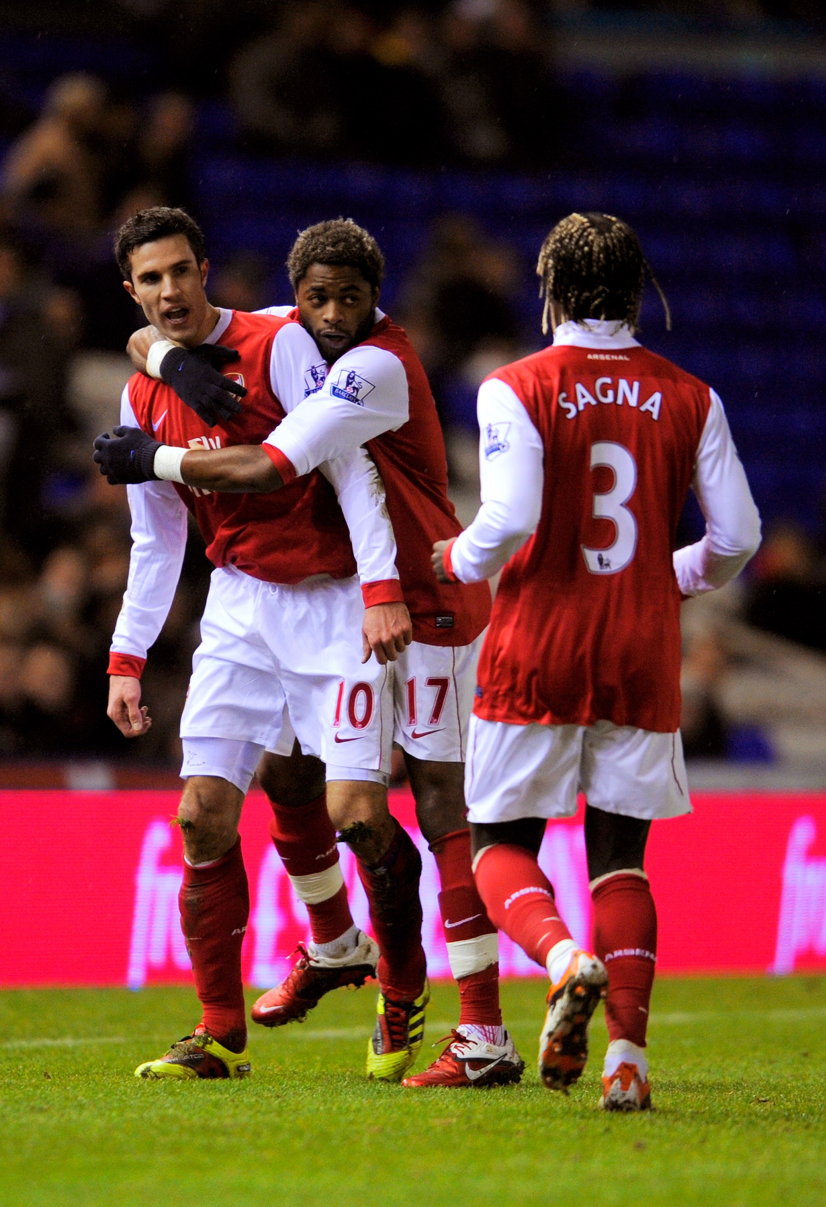 BIRMINGHAM, ENGLAND - JANUARY 01:  Robin Van Persie (L) of Arsenal is congratulated by teammates Alex Song (c) and Bacary Sagna (R) after scoring the opening goal of the match during the Barclays Premier Leaue match between Birmingham City and Arsenal at