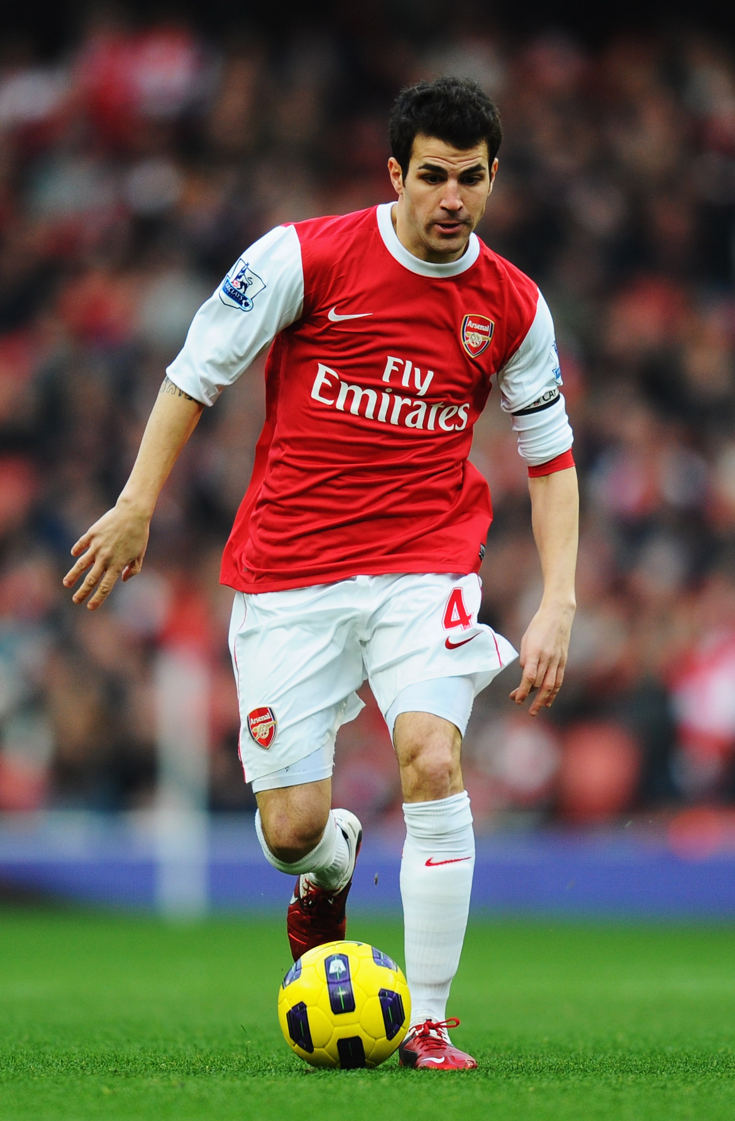 LONDON, UNITED KINGDOM - JANUARY 22:  Cesc Fabregas of Arsenal runs with the ball during the Barclays Premier League match between Arsenal and Wigan Athletic at the Emirates Stadium on January 22, 2011 in London, England.  (Photo by Mike Hewitt/Getty Imag
