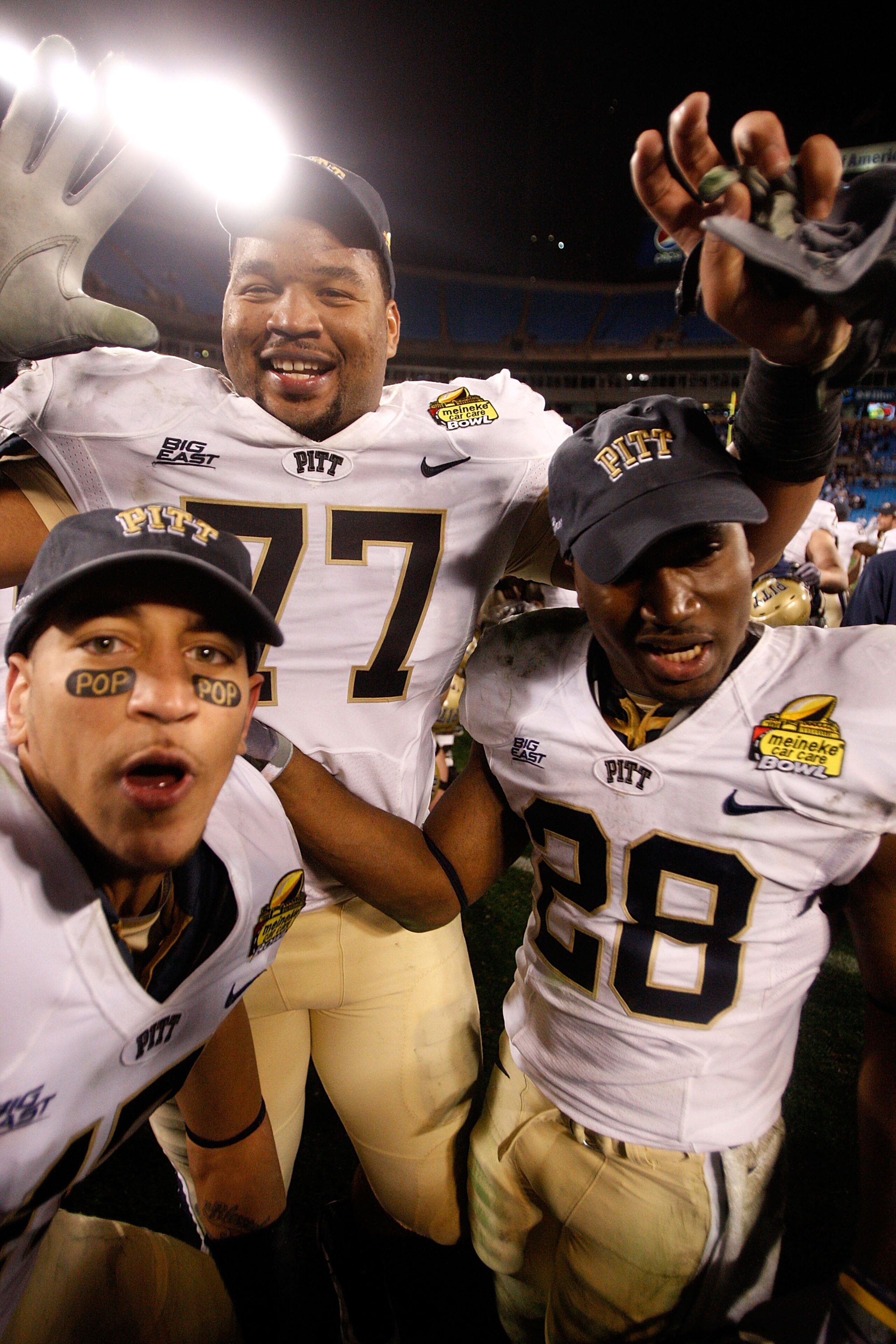 CHARLOTTE, NC - DECEMBER 26:  Teammates Jason Pinkston #77 and Dion Lewis #28 of the Pittsburgh Panthers celebrates after a 19-17 victory over the North Carolina Tar Heels on December 26, 2009 in Charlotte, North Carolina.  (Photo by Streeter Lecka/Getty