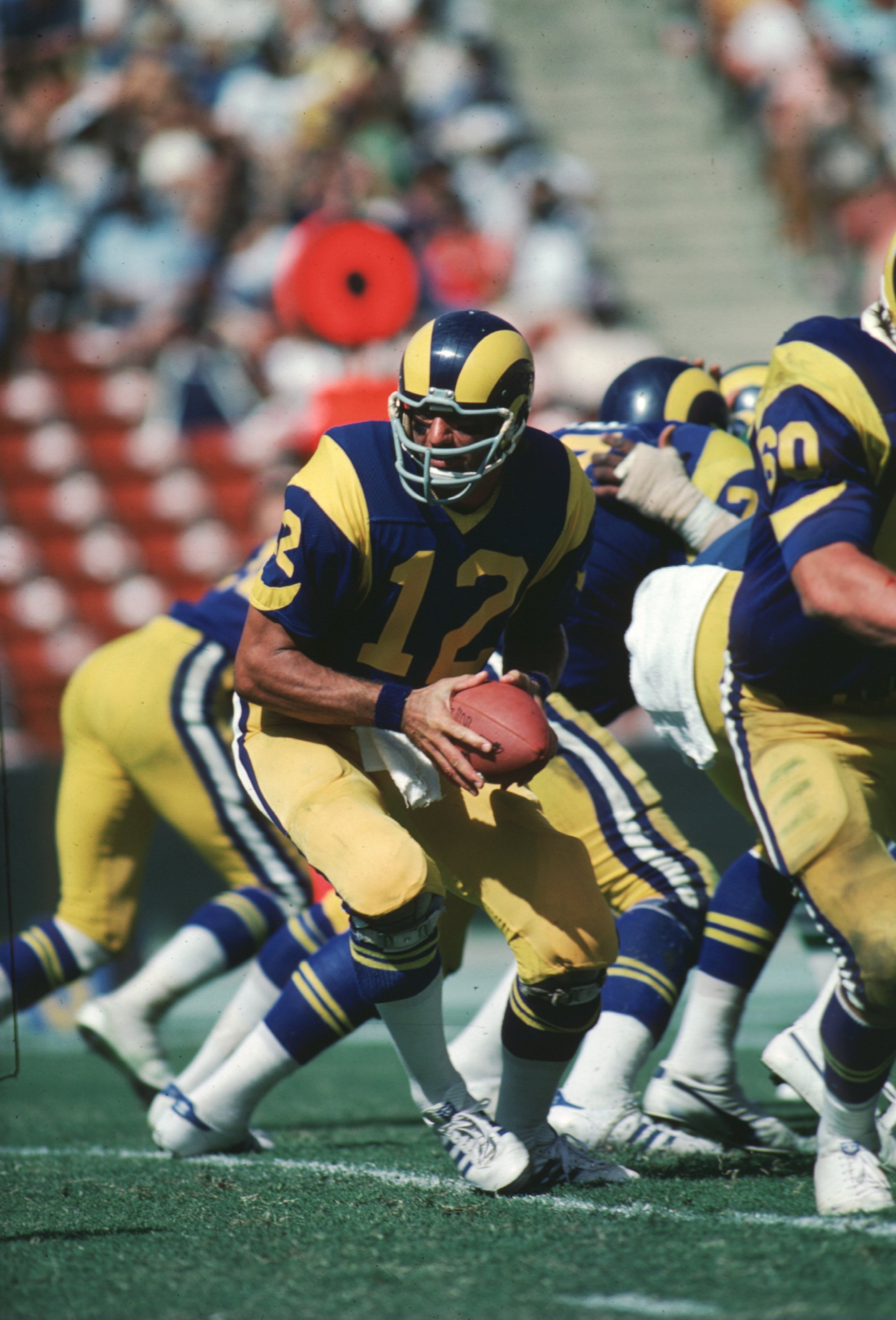 Quarterback Joe Namath of the LA Rams drops back in the pocket to turn the hand off during a game at the LA Memorial Coliseum in Los Angeles, California.