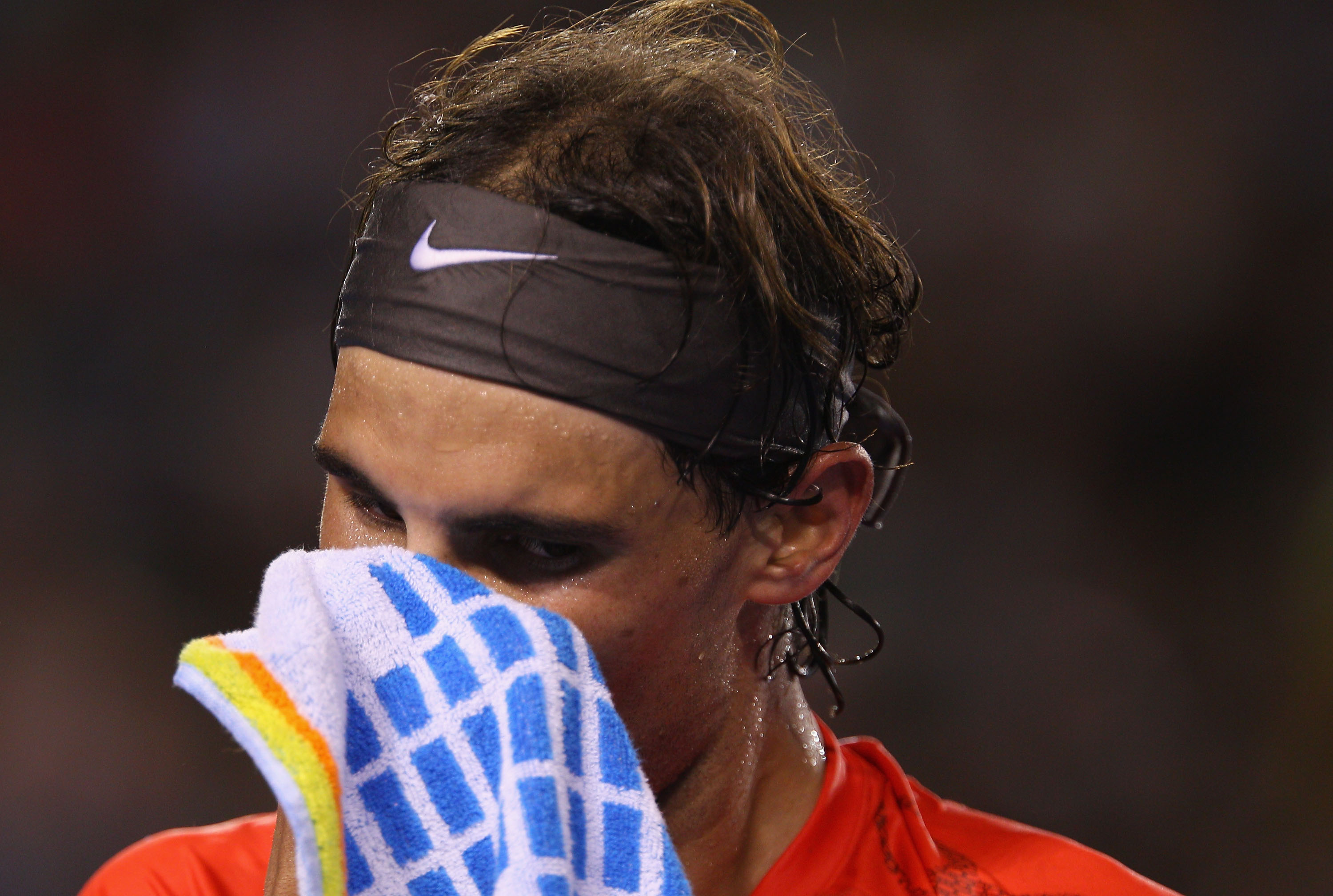 MELBOURNE, AUSTRALIA - JANUARY 22:  Rafael Nadal of Spain towels down between games in his third round match against Bernard Tomic of Australia during day six of the 2011 Australian Open at Melbourne Park on January 22, 2011 in Melbourne, Australia.  (Pho