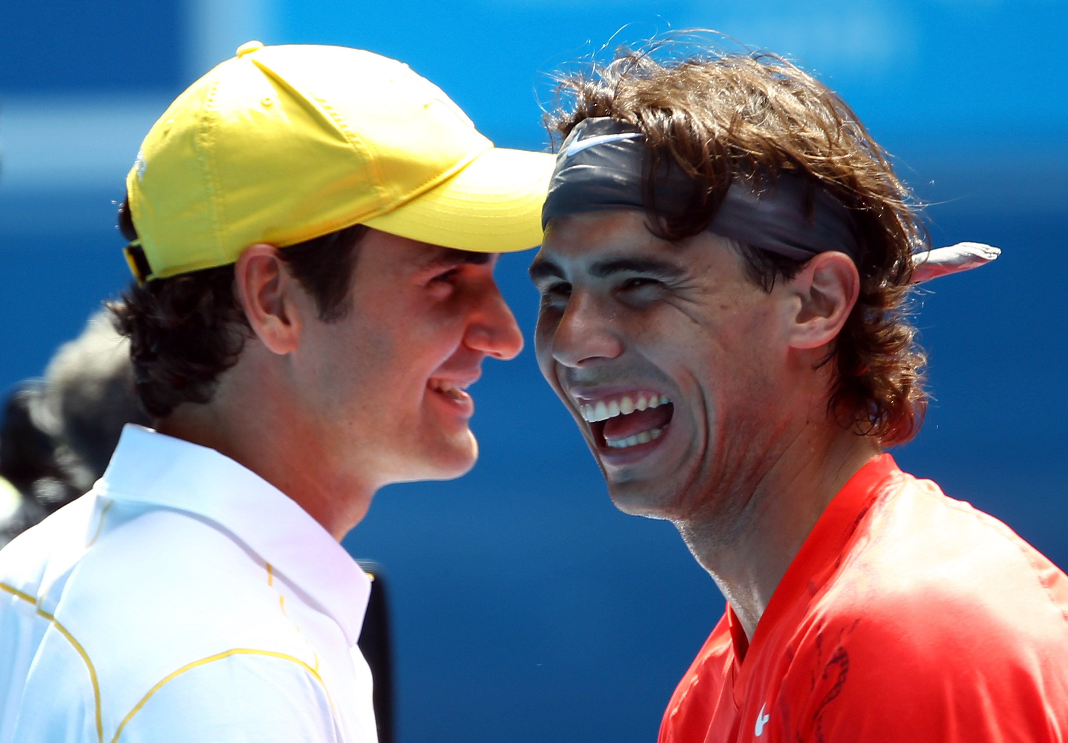 MELBOURNE, AUSTRALIA - JANUARY 16: Rafael Nadal of Spain and Roger Federer of Switzerland enjoy the day during the 'Rally For Relief' charity exhibition match ahead of the 2011 Australian Open at Melbourne Park on January 16, 2011 in Melbourne, Australia.