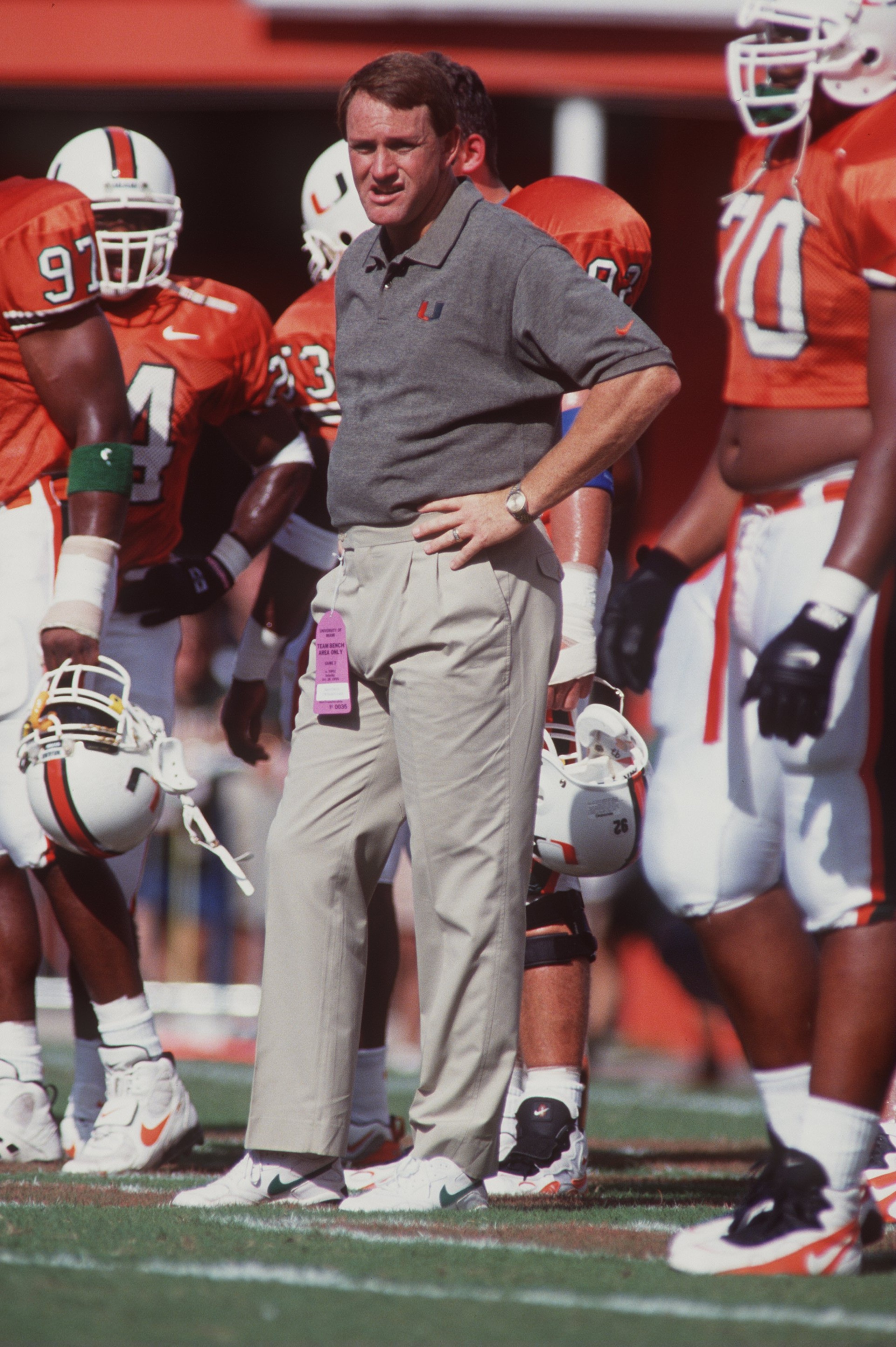 28 Oct 1995: Head coach Butch Davis of the Miami Hurricanes stands on the field amongst his players as he observes pre game warm ups before the Hurricanes 36-12 victory over the Temple Owls at the Orange Bowl in Miami, Florida.