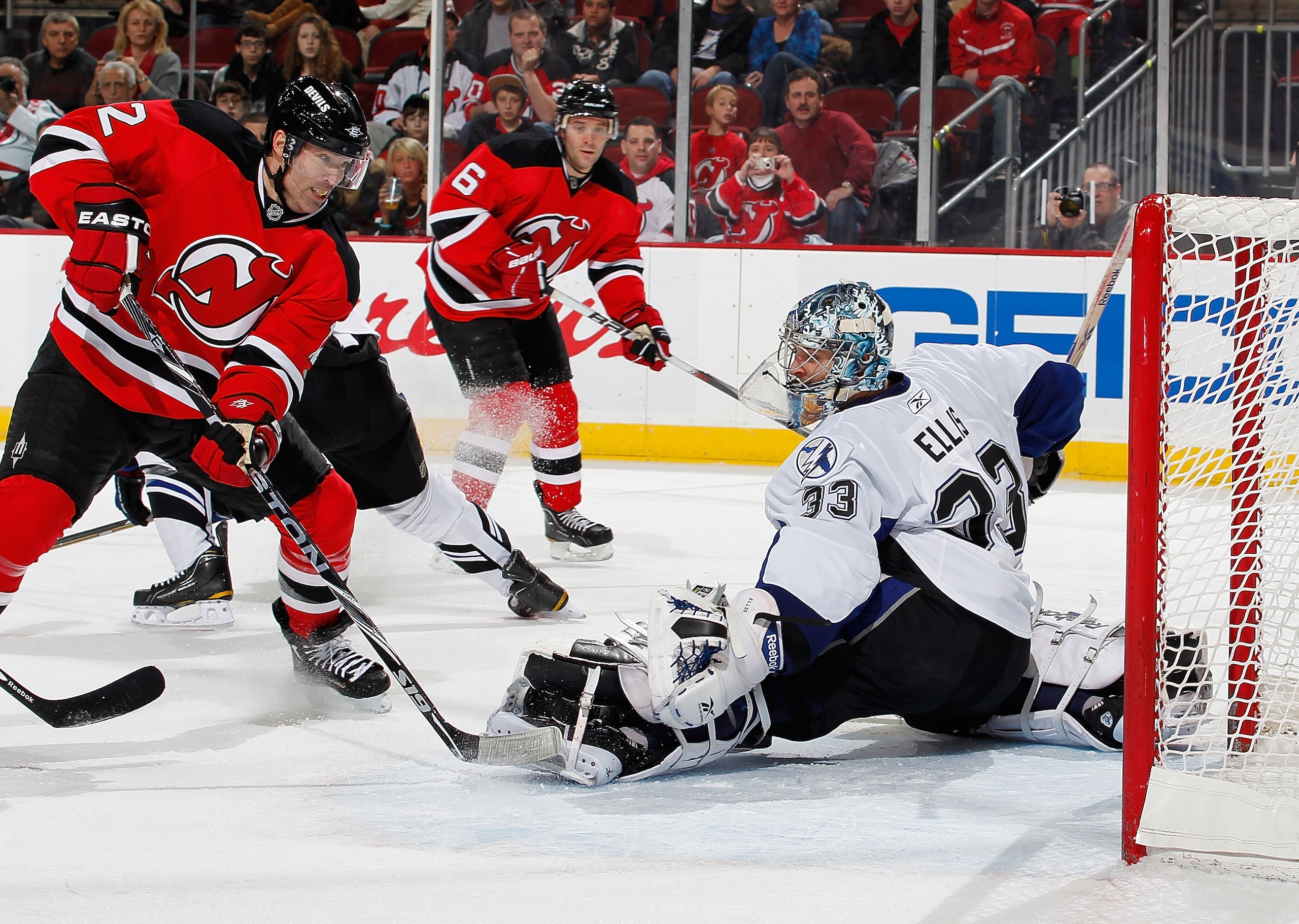 NEWARK, NJ - JANUARY 09: Goalie Dan Ellis #33 of the Tampa Bay Lightning makes a save on a shot by Brian Rolston #12 of the New Jersey Devils in the second period of an NHL hockey game at the Prudential Center on January 9, 2011 in Newark, New Jersey. (Ph