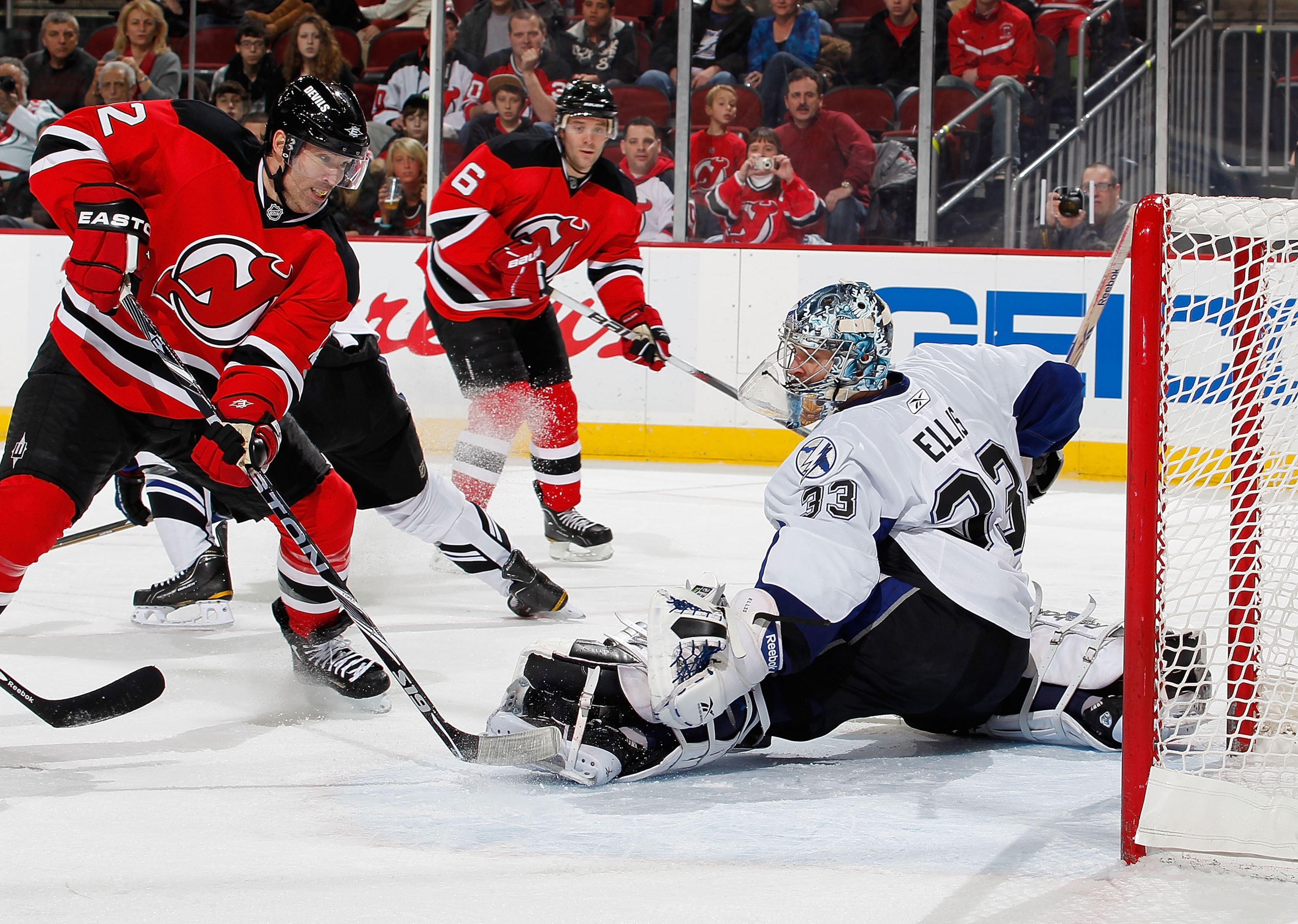 NEWARK, NJ - JANUARY 09: Goalie Dan Ellis #33 of the Tampa Bay Lightning makes a save on a shot by Brian Rolston #12 of the New Jersey Devils in the second period of an NHL hockey game at the Prudential Center on January 9, 2011 in Newark, New Jersey. (Ph
