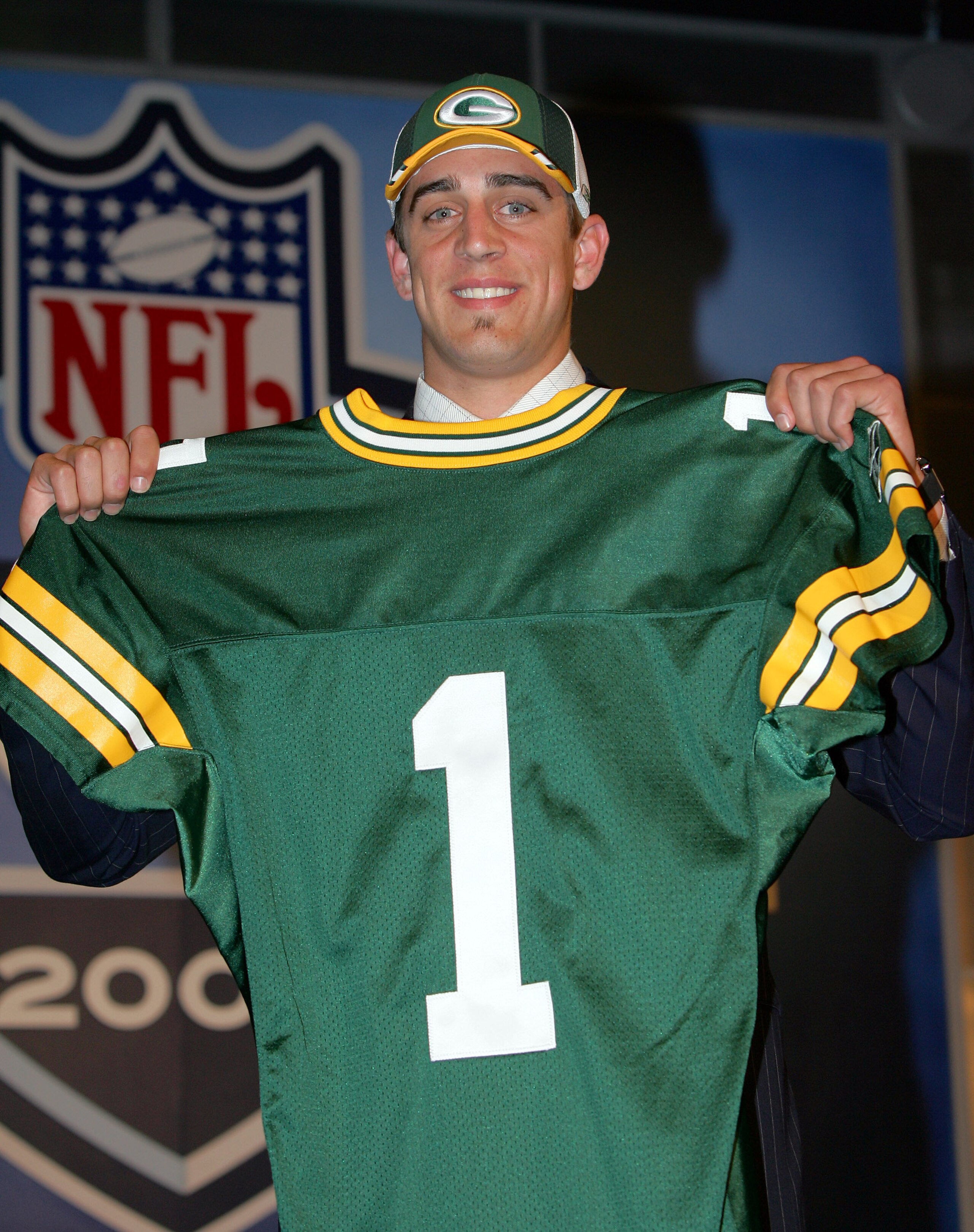 NEW YORK - APRIL 23: Quarterback Aaron Rodgers (California) poses with his jersey after being drafted 24th overall by the Green Bay Packers during the 70th NFL Draft on April 23, 2005 at the Jacob K. Javits Convention Center in New York City. (Photo by NEW YORK - APRIL 23: Quarterback Aaron Rodgers (California) poses with his jersey after being drafted 24th overall by the Green Bay Packers during the 70th NFL Draft on April 23, 2005 at the Jacob K. Javits Convention Center in New York City. (Photo by