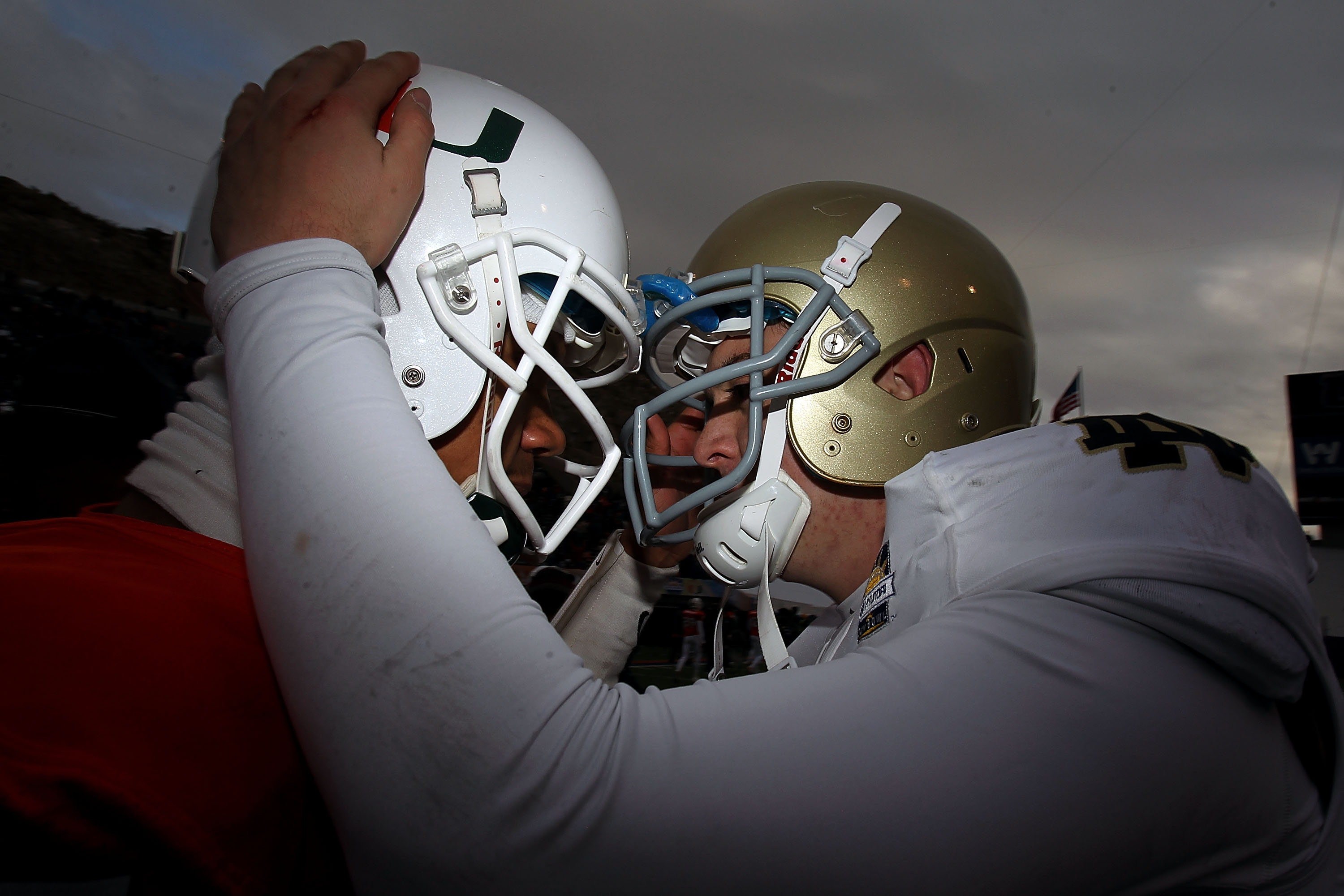 EL PASO, TX - DECEMBER 30:  (L-R) Stephen Morris #17  of the Miami Hurricanes hugs Tommy Rees #13 of the Notre Dame Fighting Irish at Sun Bowl on December 30, 2010 in El Paso, Texas.  (Photo by Ronald Martinez/Getty Images)