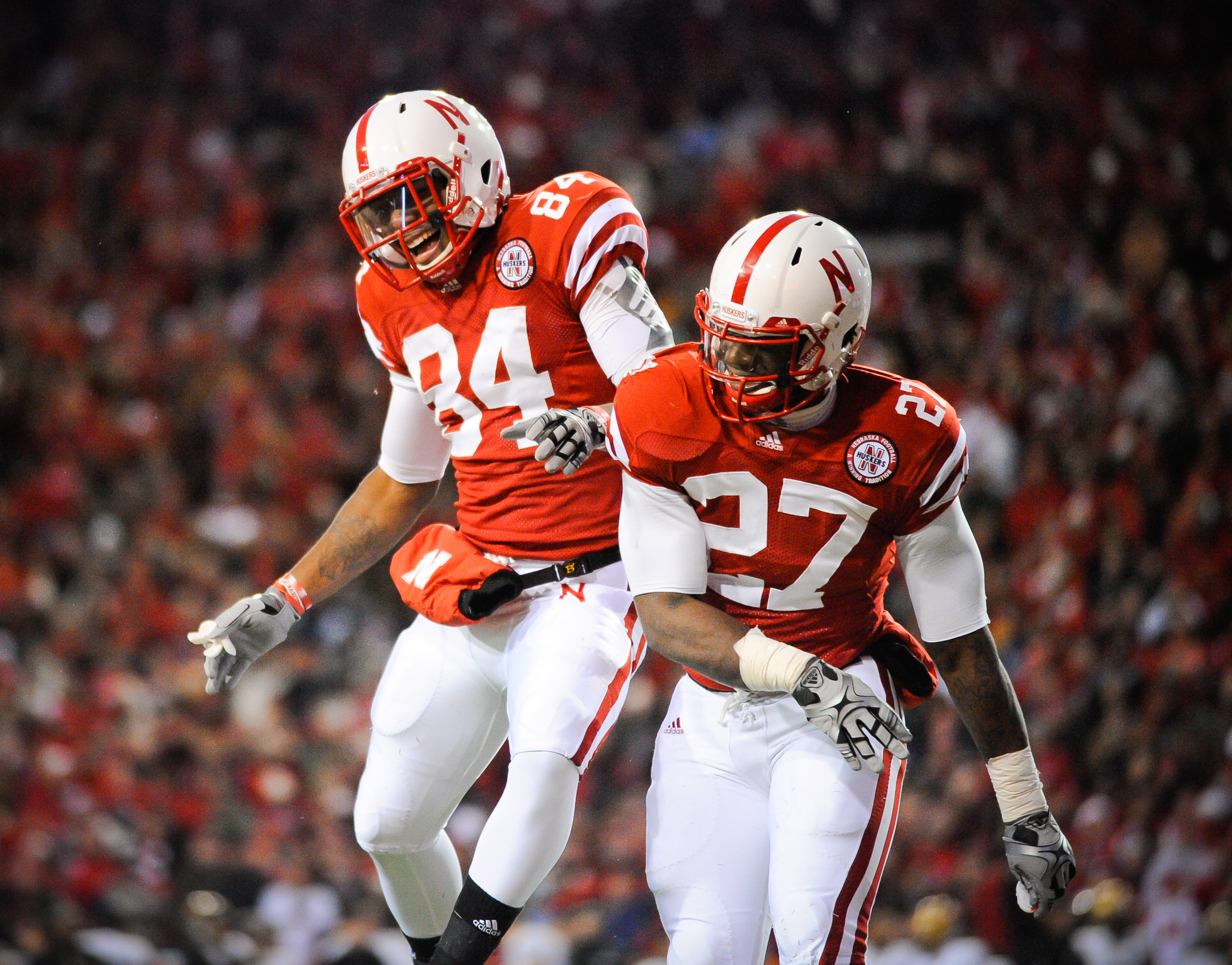 LINCOLN, NE - NOVEMBER 26: Dontrayevous Robinson #27 and Brandon Kinnie #84 of the Nebraska Cornhuskers celebrate a touchdown during their game against the Colorado Buffaloes at Memorial Stadium on November 26, 2010 in Lincoln, Nebraska. Nebraska defeated