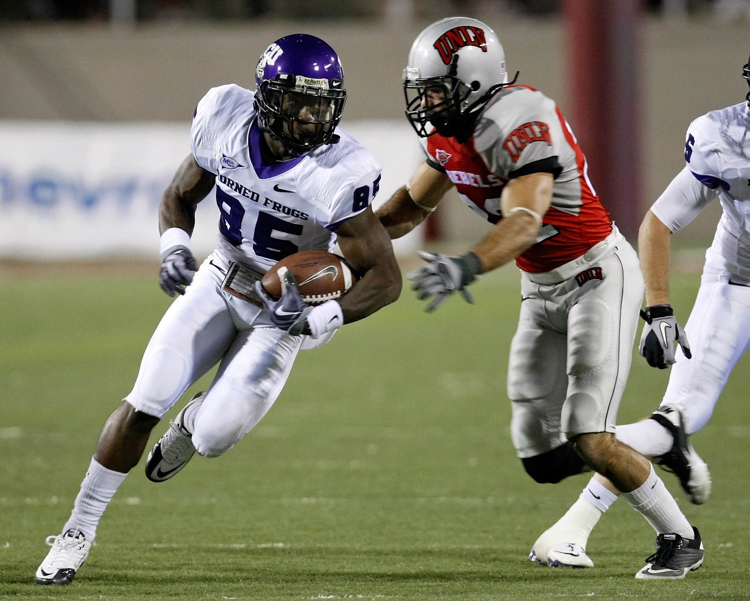 LAS VEGAS - OCTOBER 30:  Jeremy Kerley #85 of the Texas Christian University Horned Frogs runs for yardage against Alex De Giacomo #22 of the UNLV Rebels during the third quarter of their game at Sam Boyd Stadium October 30, 2010 in Las Vegas, Nevada. TCU