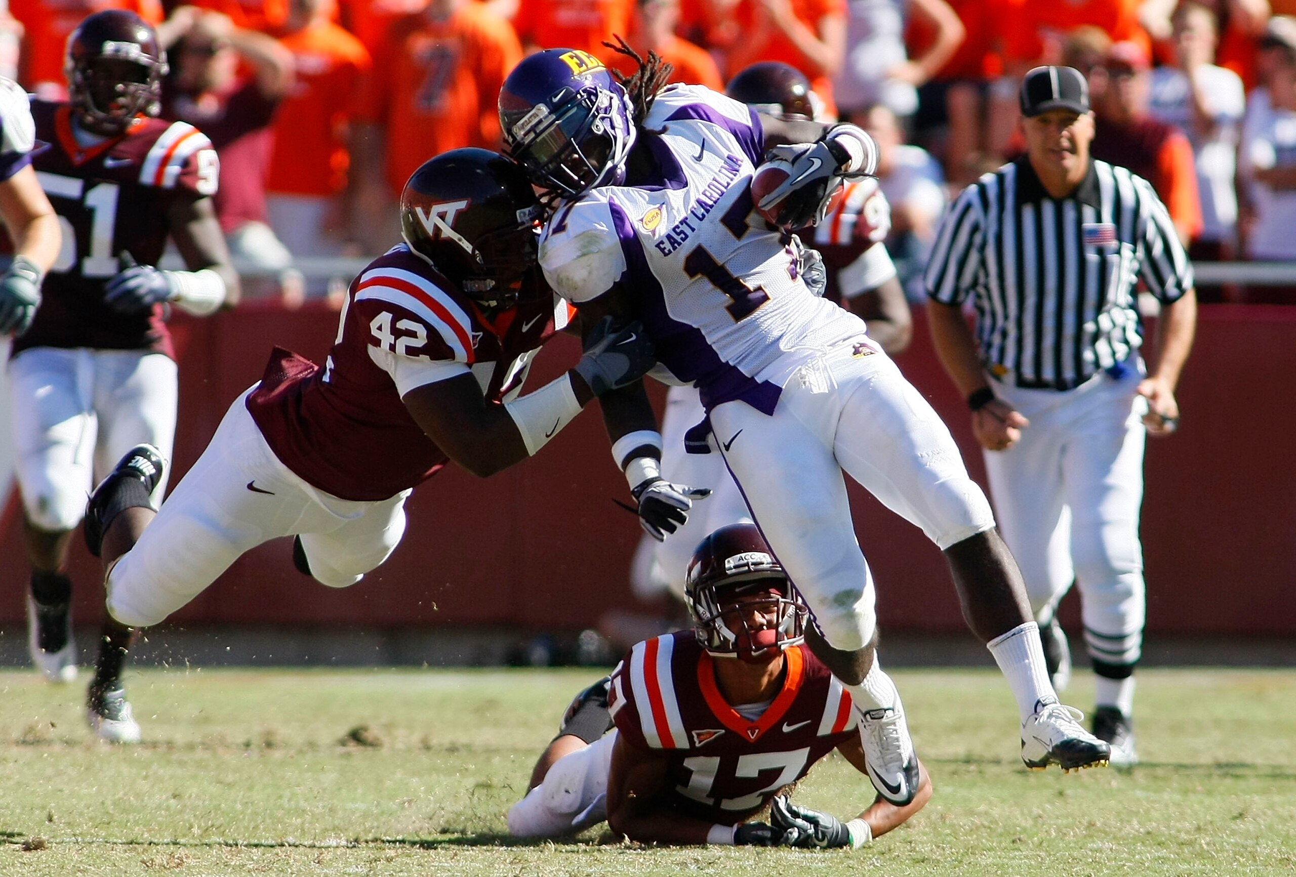 BLACKSBURG, VA - SEPTEMBER 18:  Defensive end J.R. Collins #42 and  cornerback Kyle Fuller #17 of the Virginia Tech Hokies tackle wide receiver Dwayne Harris #17 of the East Carolina Pirates at Lane Stadium on September 18, 2010 in Blacksburg, Virginia.