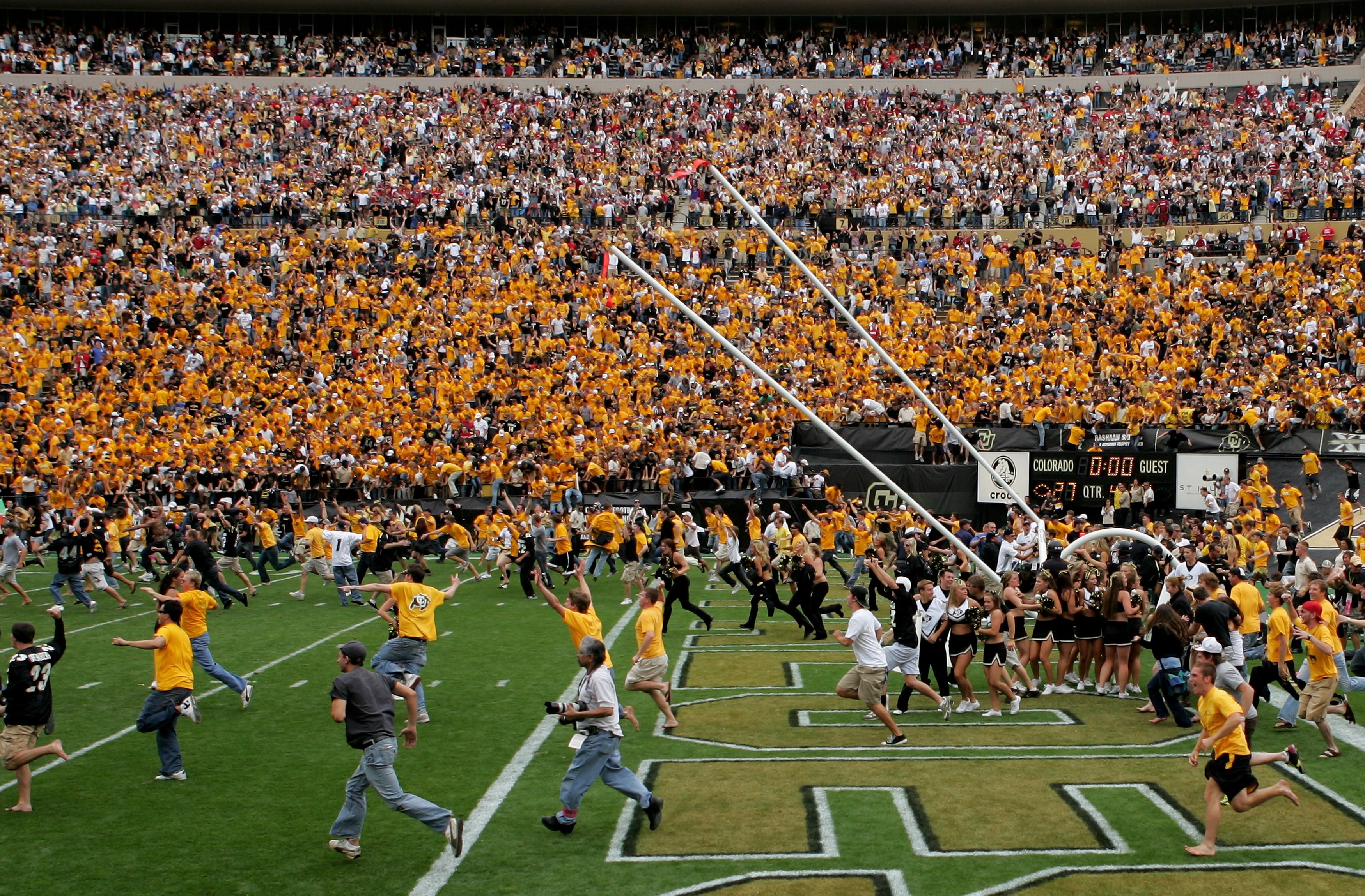 BOULDER, CO - SEPTEMBER 29:  The goal posts are lowered as the fans swarm the field after place kicker Kevin Eberhart of the Colorado Buffaloes kicked the game winning field goal as time expires against the Oklahoma Sooners at Folsom Field on September 29