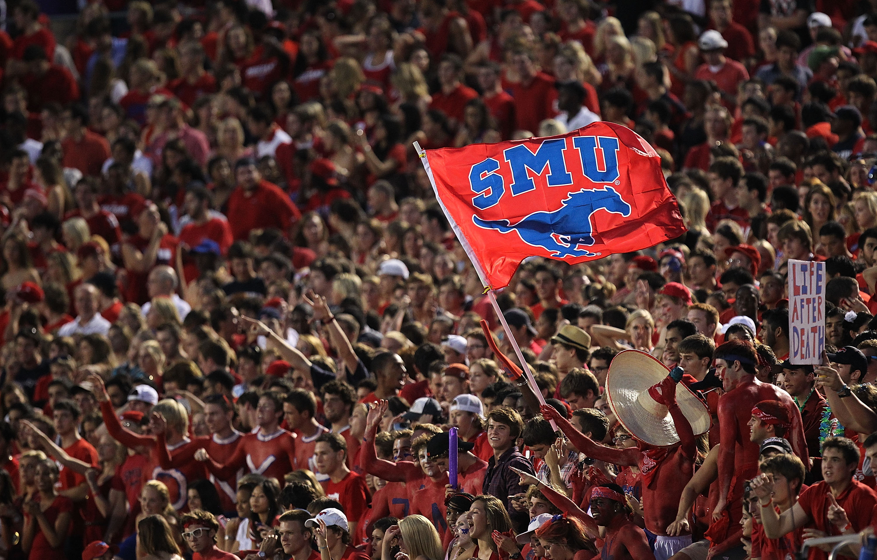 DALLAS - SEPTEMBER 24:  Fans of the SMU Mustangs wave a flag during play against the TCU Horned Frogs at Gerald J. Ford Stadium on September 24, 2010 in Dallas, Texas.  (Photo by Ronald Martinez/Getty Images)