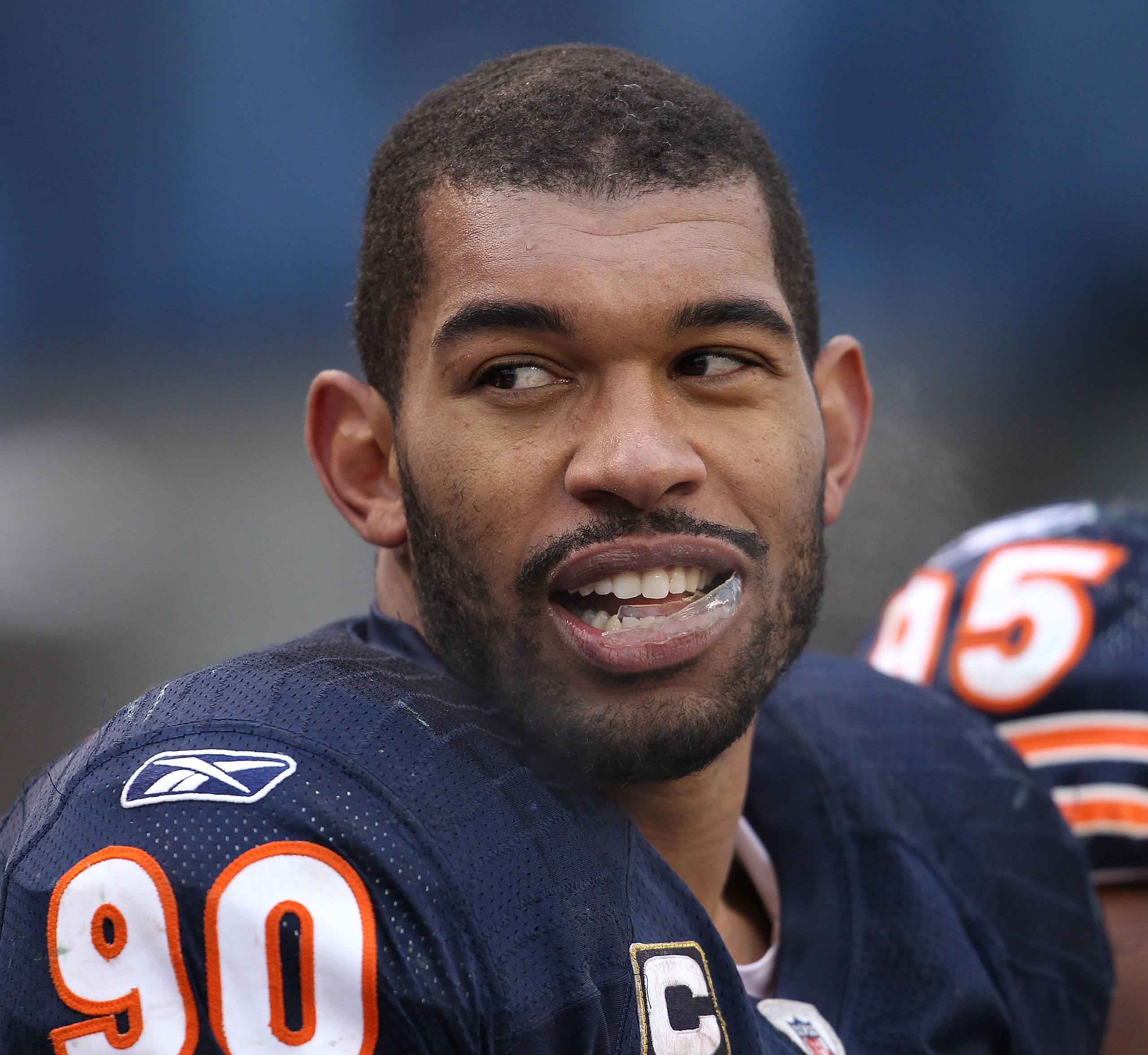 CHICAGO, IL - DECEMBER 26: Julius Peppers #90 of the Chicago Bears talks with a teammate on the bench during a game against the New York Jets at Soldier Field on December 26, 2010 in Chicago, Illinois. The Bears defeated the Jets 38-34. (Photo by Jonathan