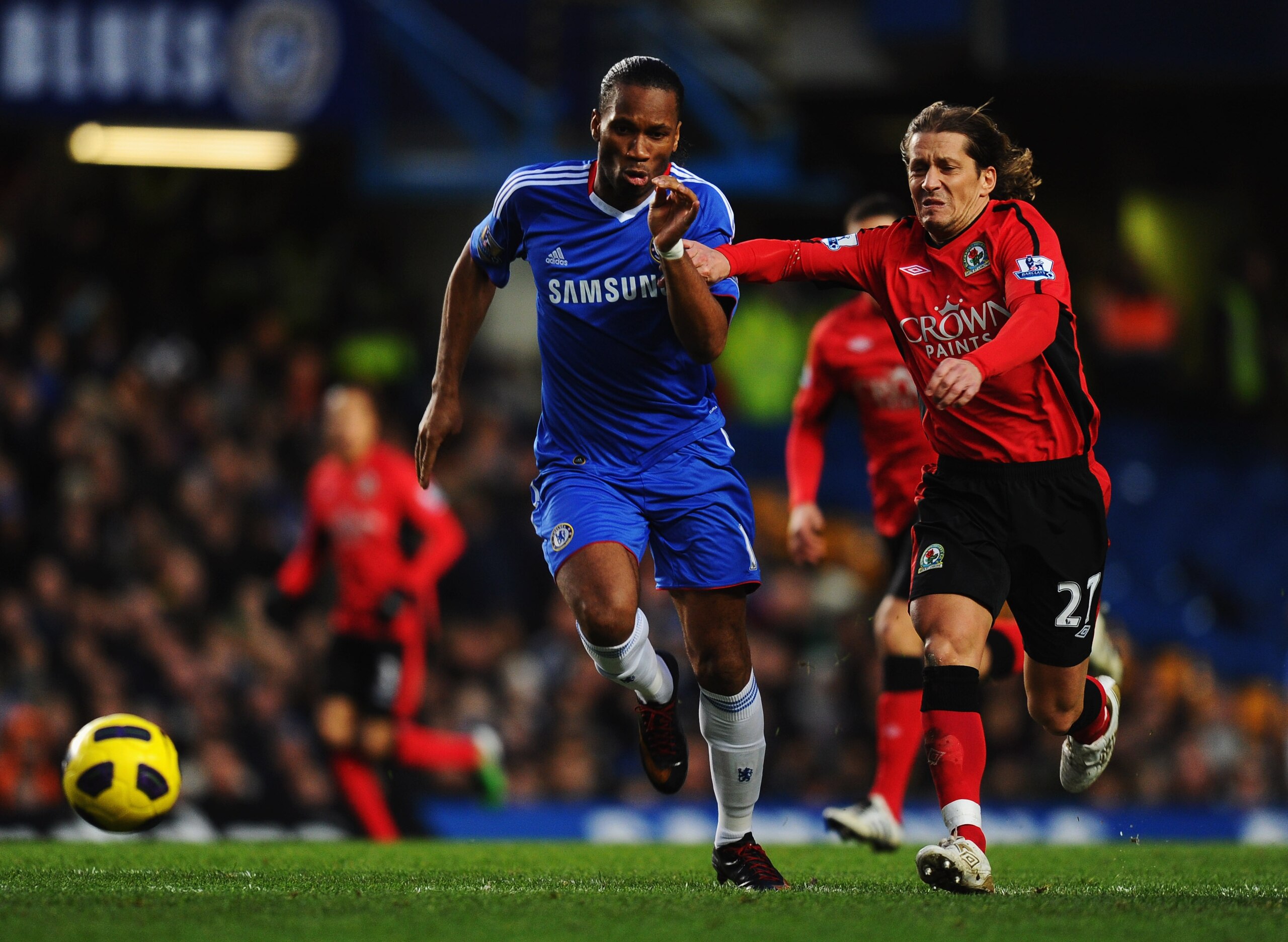 LONDON, ENGLAND - JANUARY 15: Didier Drogba of Chelsea chases the ball with Michel Salgado of Blackburn Rovers during the Barclays Premier League match between Chelsea and Blackburn Rovers at Stamford Bridge on January 15, 2011 in London, England. (Phot LONDON, ENGLAND - JANUARY 15: Didier Drogba of Chelsea chases the ball with Michel Salgado of Blackburn Rovers during the Barclays Premier League match between Chelsea and Blackburn Rovers at Stamford Bridge on January 15, 2011 in London, England. (Phot