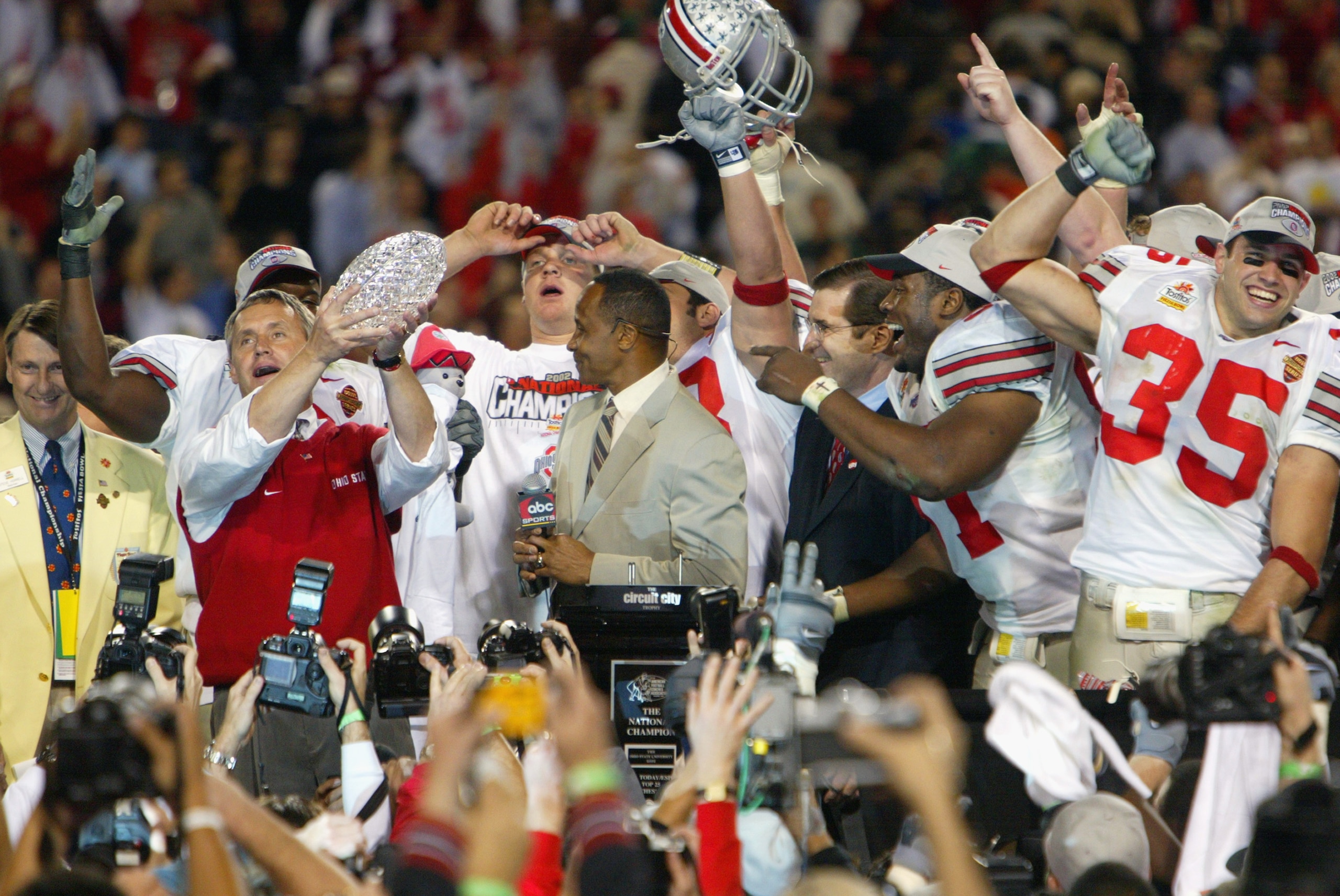 TEMPE, AZ - JANUARY 3:  Head coach Jim Tressel raises the trophy as the Ohio State Buckeyes celebrate the victory over the University of Miami Hurricanes during the Tostitos Fiesta Bowl at Sun Devil Stadium on January 3, 2003 in Tempe, Arizona.  Ohio Stat